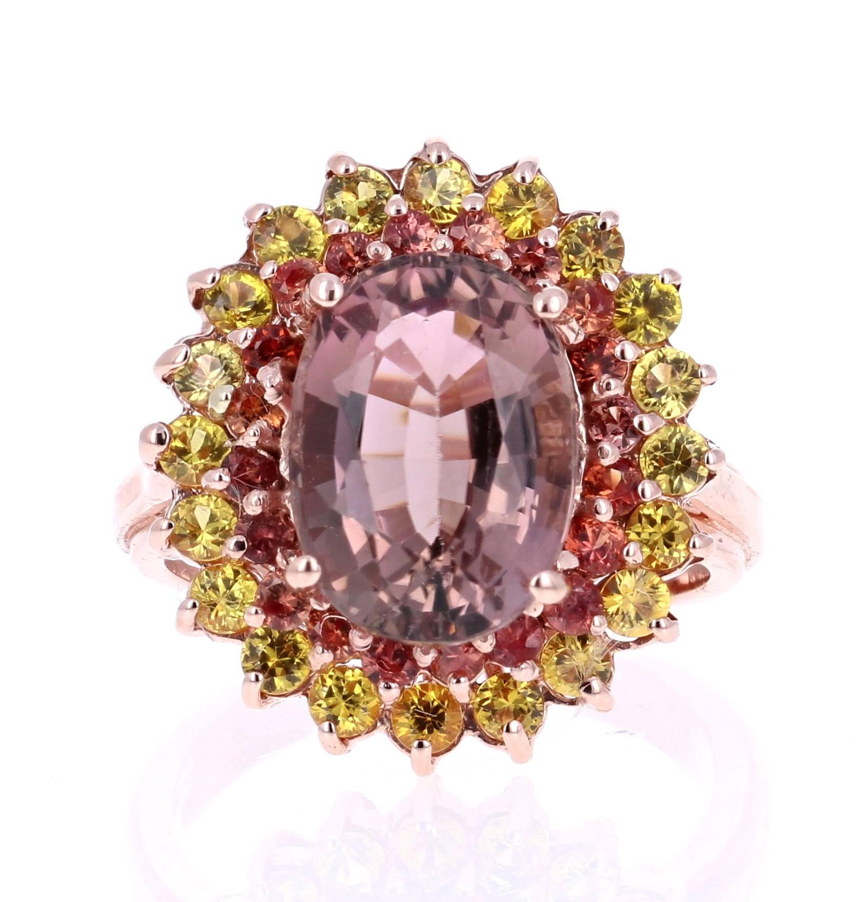 Stunning and uniquely designed 6.86 Carat Sapphire Tourmaline Rose Gold Cocktail Ring!

This ring has a 5.12 carat Oval Cut Tourmaline that is set in the center of the ring and is surrounded by 20 Round Cut Orange Sapphires that weigh 0.64 carats