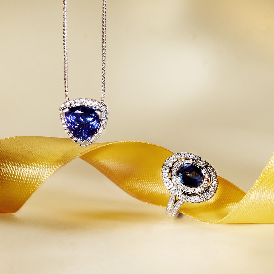A classic beauty, our Trilliant Tanzanite and Diamond Pendant showcases a rare, deep coloured 6.86ct Trilliant Cut Tanzanite, set in 18k White Gold and delicately encased with a Halo of Fine White Diamonds (totalling 0.39CT H/SI). The pendant sits