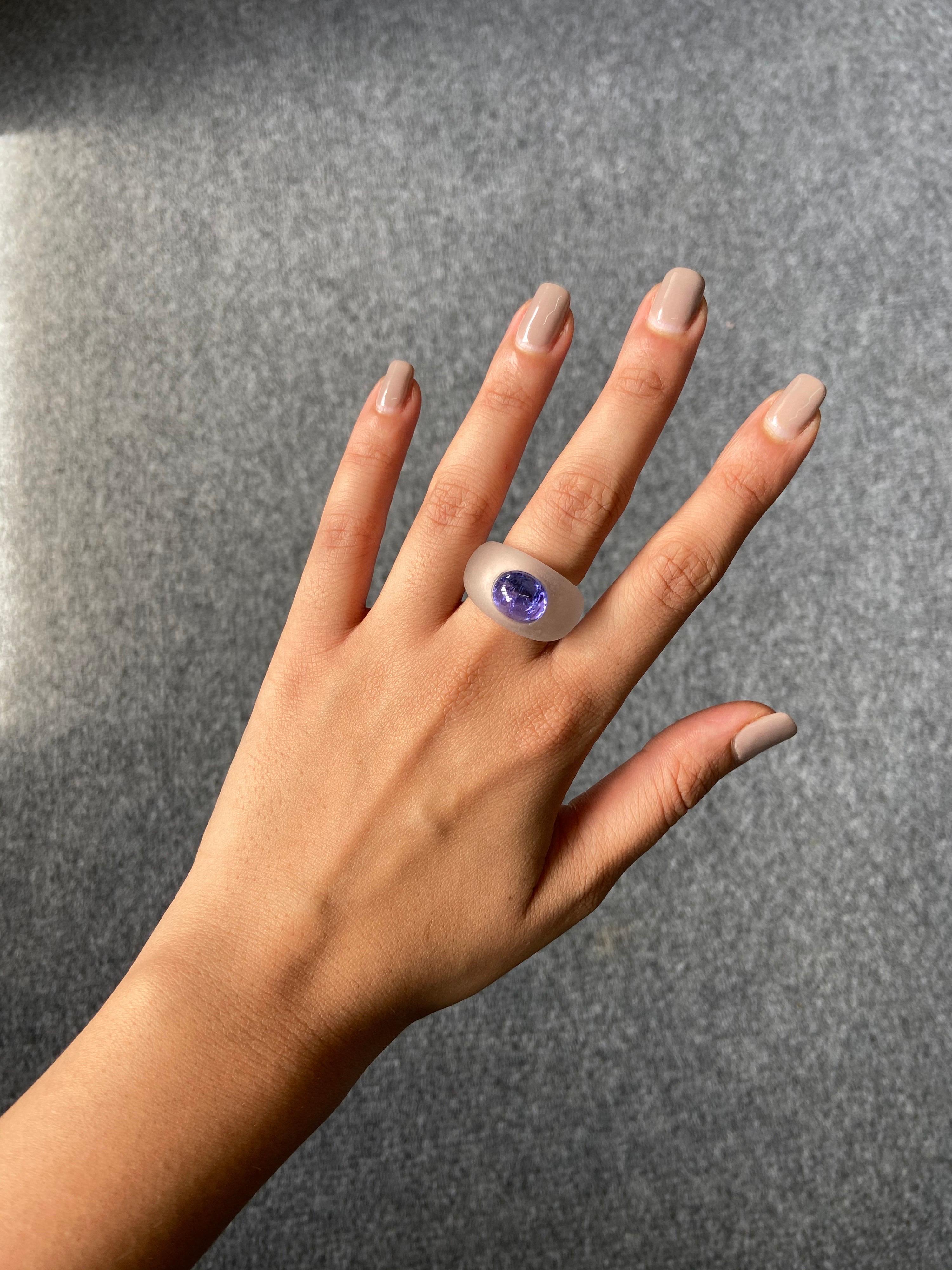 6.87 carats of Tanzanite Cabochon, studded in Rock Crystal. The natural Tanzanite is transparent, with naturally occuring inclusions making is a very unique stone. The ring is currently sized US 6, but it can be resized according to the client.