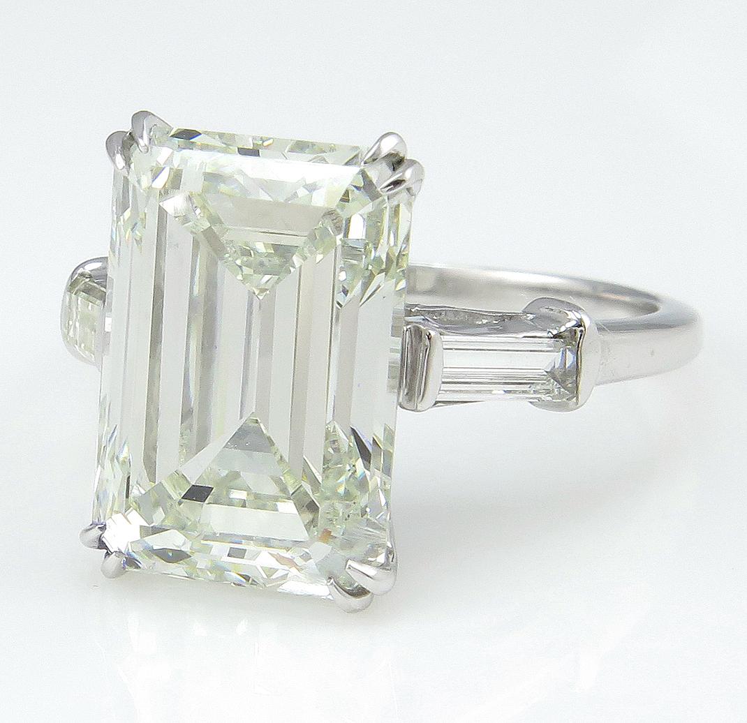 This Important exceptionally beautiful EMERALD cut diamond ring in Platinum CIRCA 1965. A HUGE 100% NATURAL NONE-treated diamond for a Great price! The total Diamond Weight is 6.87ctw. Although The Center Diamond weighing a 6.47 carats, due to its