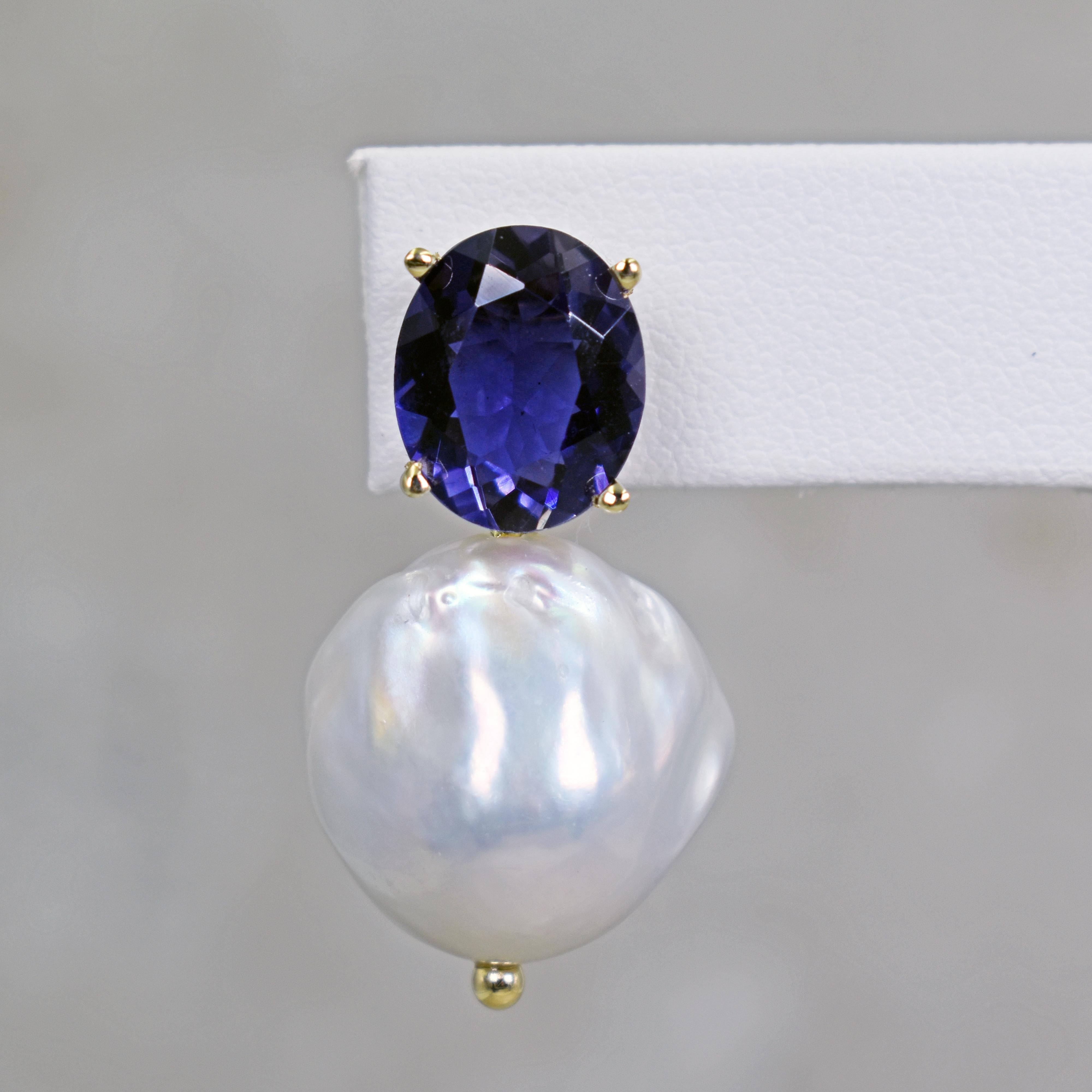 Gorgeous and unique 14k yellow gold stud earrings featuring two oval-cut Iolite gemstones, totaling 6.88 carats, and Freshwater Baroque Pearls. Stud earrings are 1.32 inches or 33 mm in length. These artisan drop earrings have timeless beauty with a