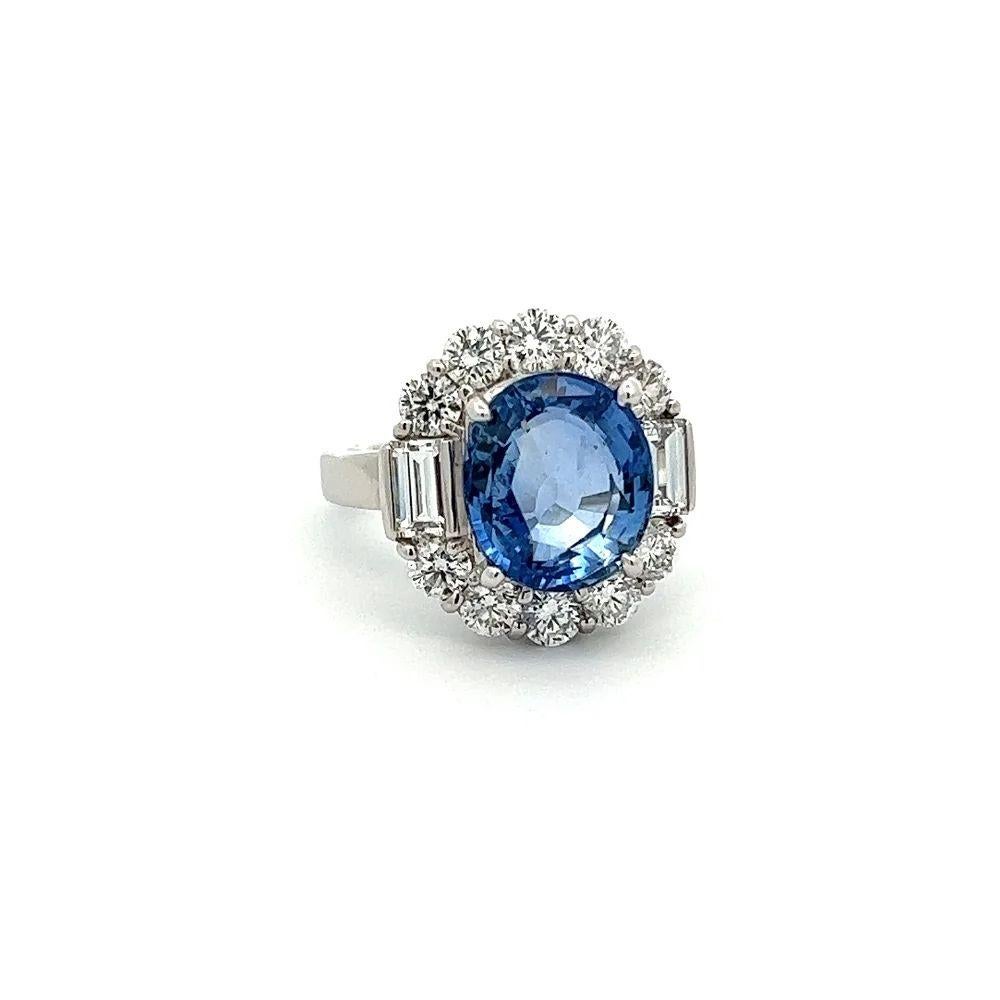 Simply Beautiful! Finely detailed Awesome NO HEAT Sapphire GIA and Diamond Platinum Ring. Centering a securely nestled Oval NO HEAT GIA Blue Sapphire weighing approx. 6.89 Carat. GIA #1415721071 lab report. Surrounded by Baguette and Round Diamonds,