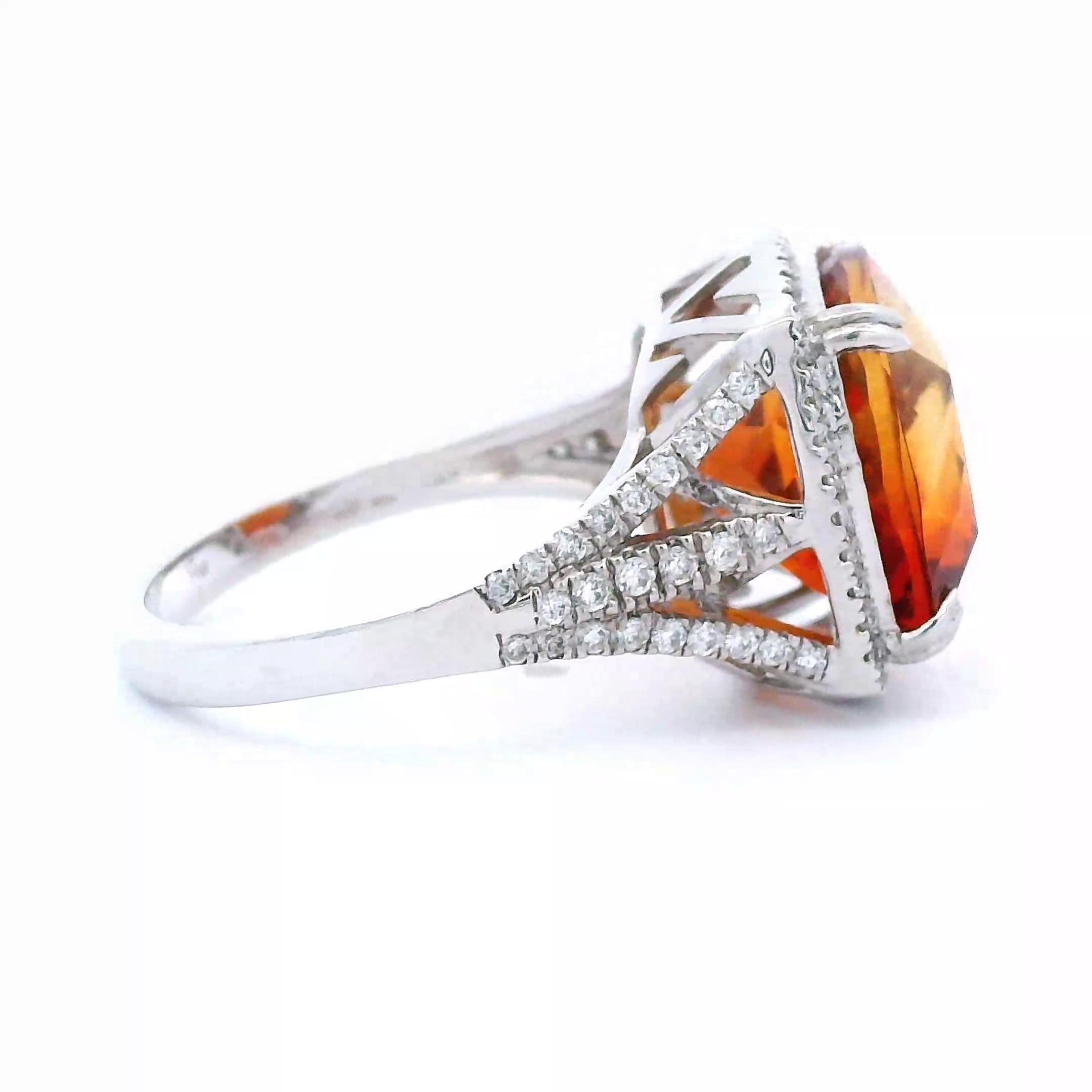 Stunning vibrant orange citrine and diamond ring.
7.35 carats total gemstone weight.
6.89 carat cushion orange citrine. 88 round brilliant diamonds, 0.46 carats. Approximately G color and VS2 clarity. 14-karat white gold, 3.82 grams, ring size 6.50
