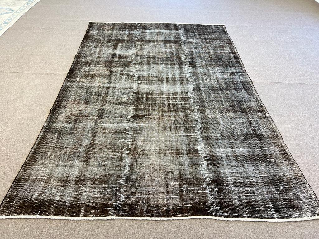 A vintage distressed Turkish area rug re-dyed in brown color, great for contemporary interiors.
Finely hand knotted, low wool pile on cotton foundation. Professionally washed.
Sturdy and can be used on a high traffic area, suitable for both