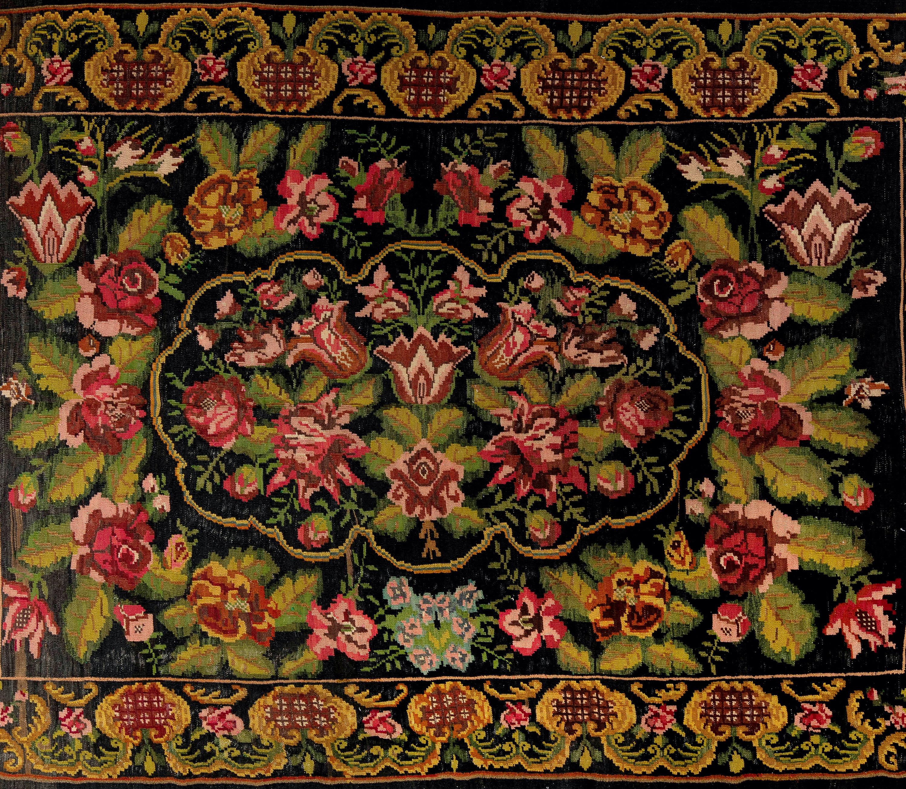 One of a kind Vintage Bessarabian Kilim. 
A hand-woven Eastern European Rug from Moldova. These traditional Moldovan flat-weaves are inspired from vintage Aubusson carpets but they are distinguished with their black grounds, large floral patterns