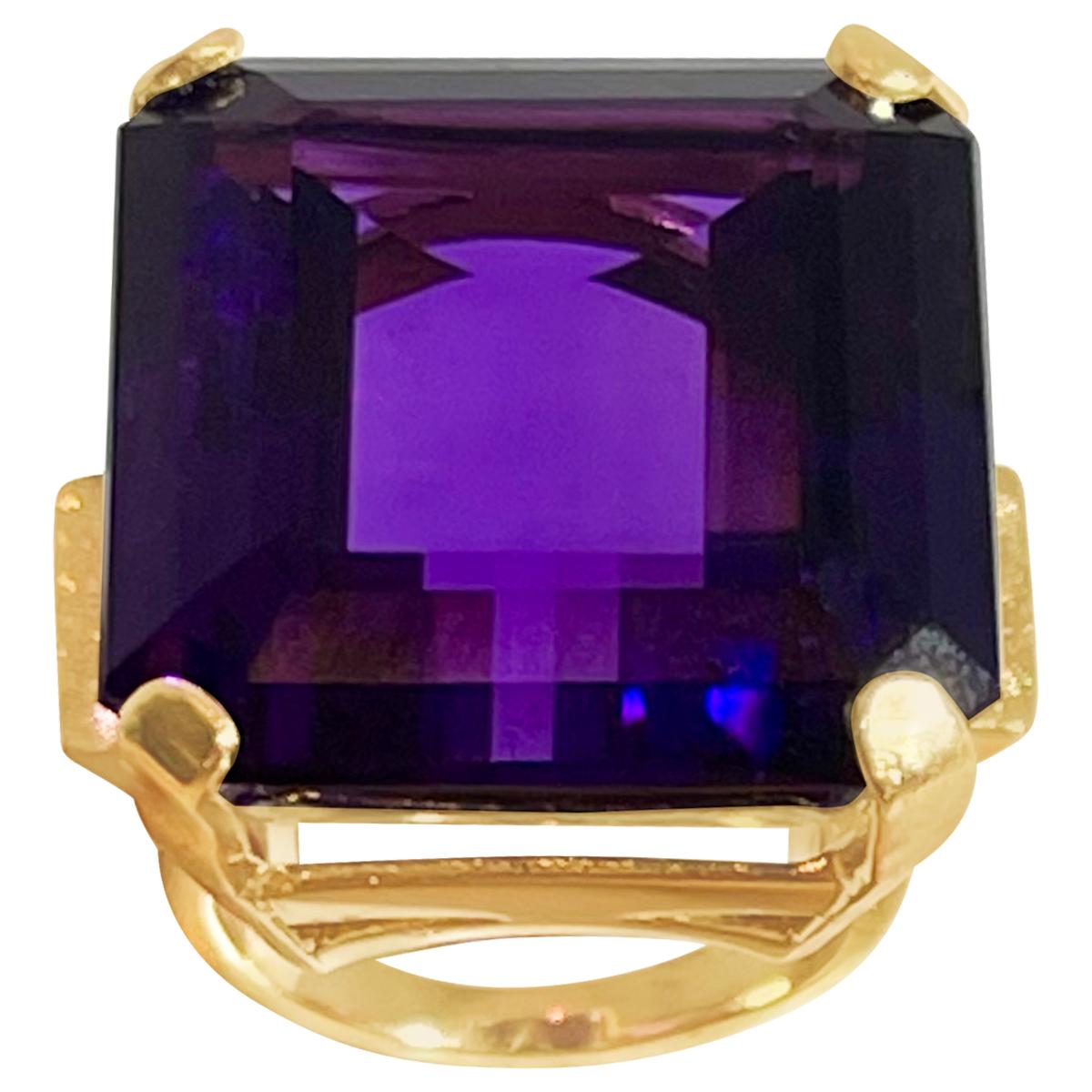 Exact 69 Carat Emerald Cut Amethyst  Cocktail Ring in 14 Karat Yellow Gold Size 9
26 X28 MM Amethyst  Cocktail Ring in 14 Karat Yellow Gold 

This is a Beautiful Cocktail ring ring which has a large 69 carat of  Amethyst . Color and clarity is nice.