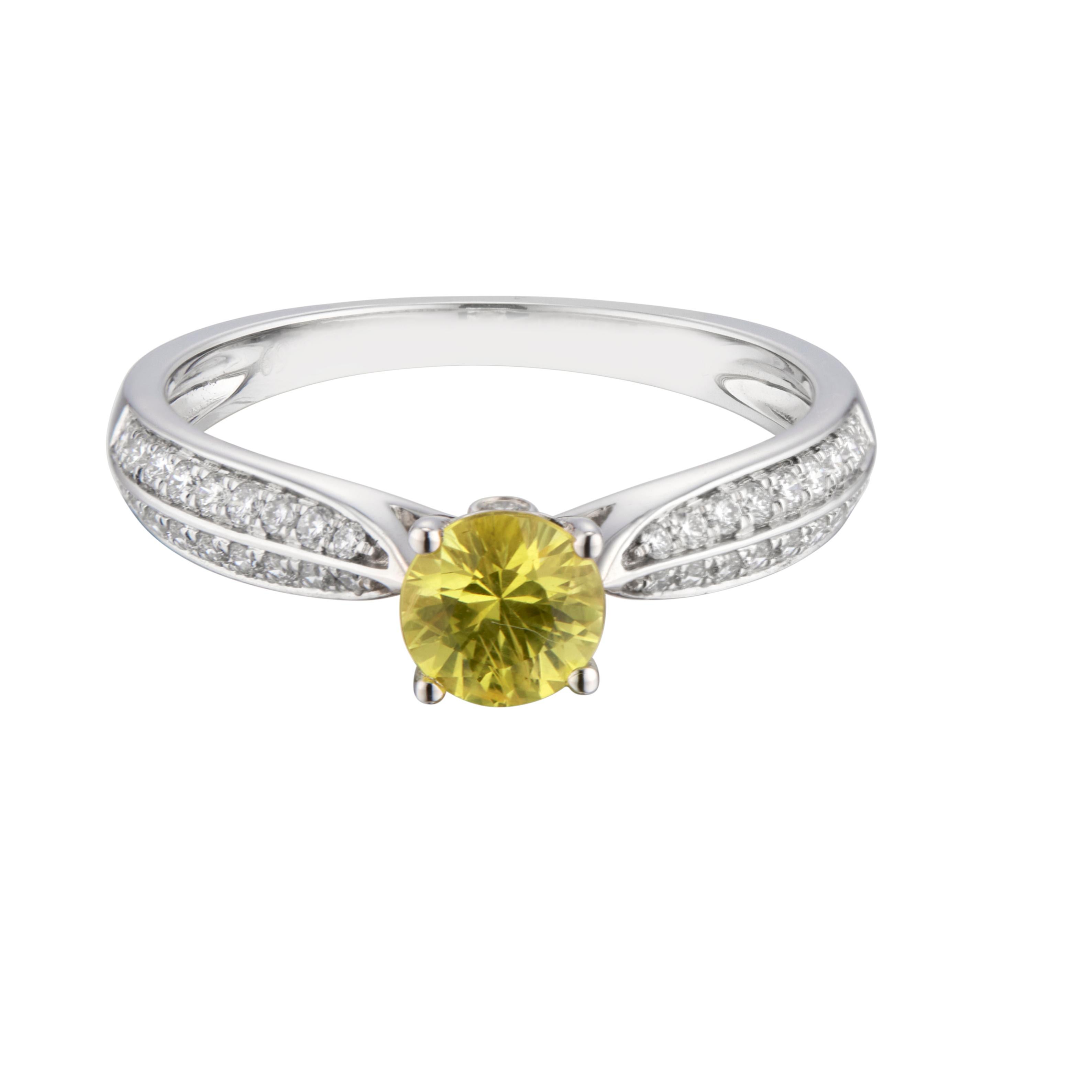 Sapphire and diamond engagement ring. Round yellow sapphire center stone in a 14k white gold solitaire setting with 38 round cut diamonds diamonds along both sides of the shank.

1 round yellow sapphire, approx. .69cts
38 round diamond, G VS-SI