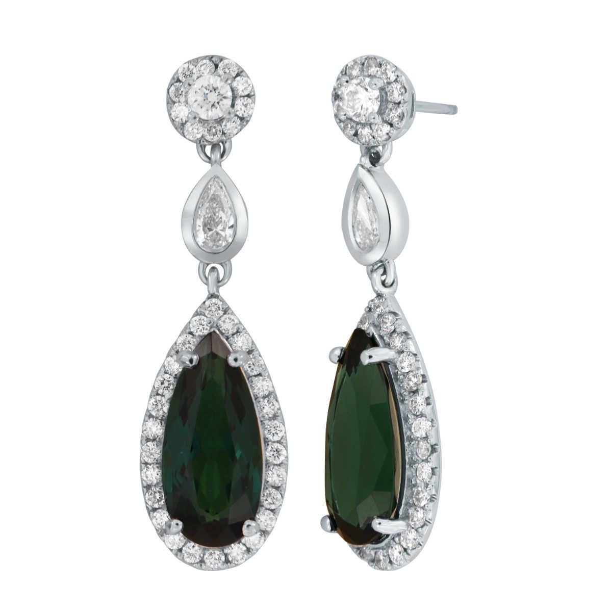 This Red Carpet style 18k White dangle earrings feature two (2) Rare  Natural pear-shaped Teal color Tourmaline with a total weight of 6.90 Carat encircled by Natural brilliant round diamonds in a total weight of 0.50 Carat. It exhibits a vibrant