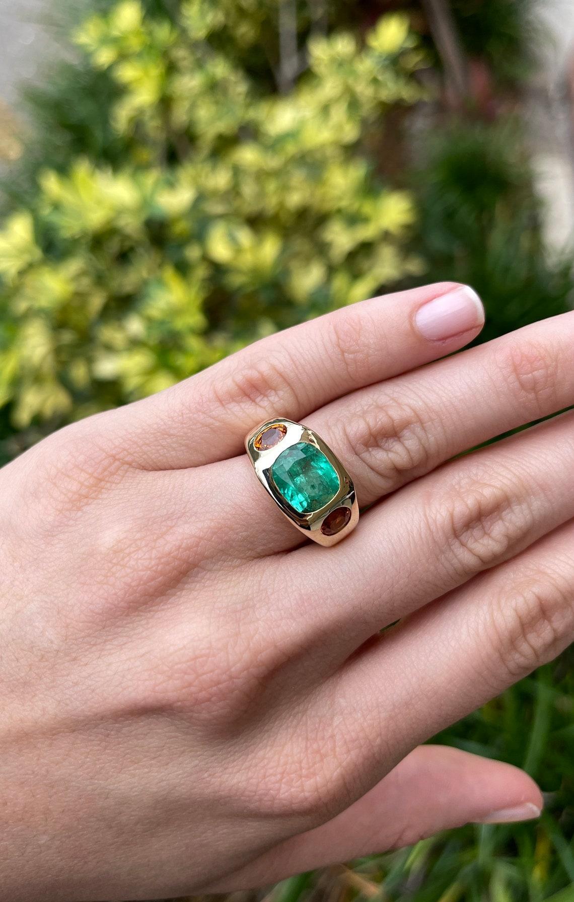 Modern 7.05tcw 14K 3 Stone Colombian Emerald & Oval Orange Sapphire Gypsy Bezel Ring For Sale