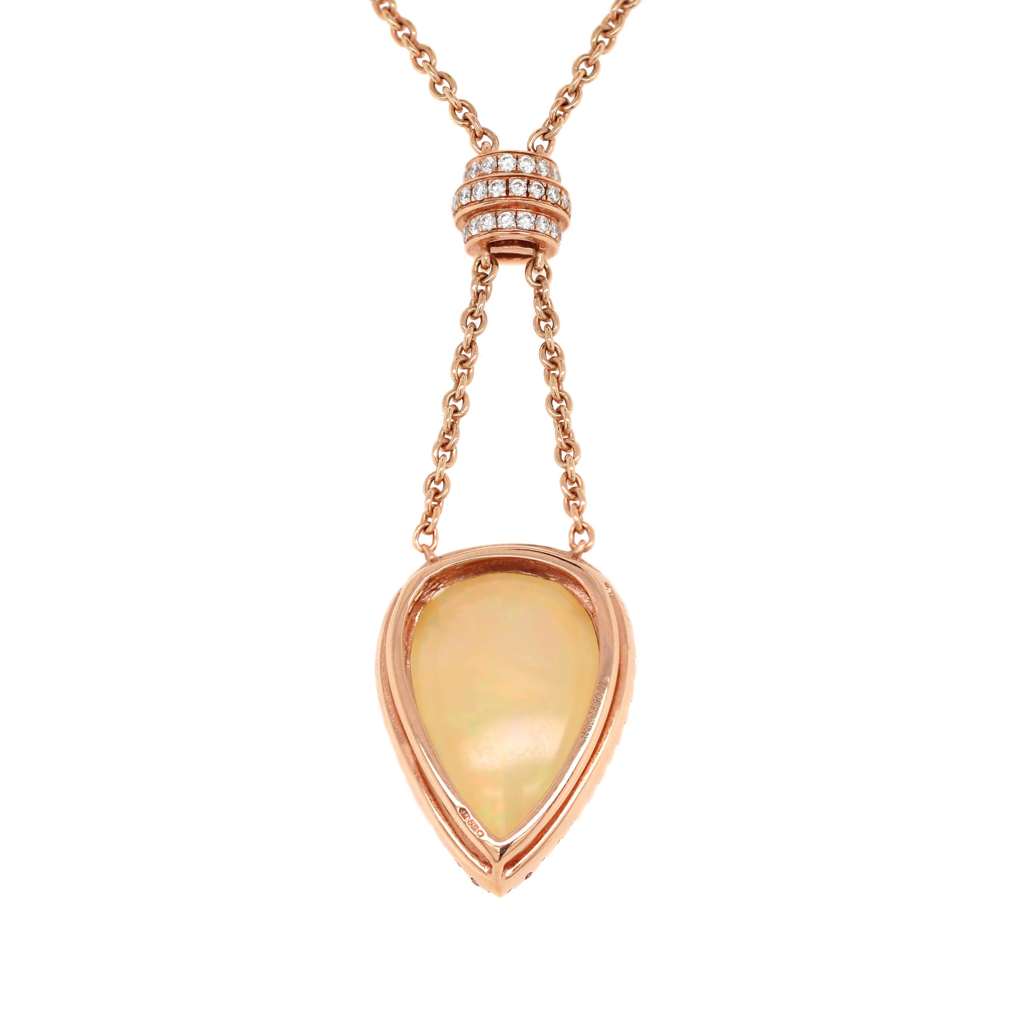 This beautiful piece features a lustrous pear shaped Ethiopian cabochon opal weighing 6.91ct mounted in a three, double claw, open back setting. The opal is beautifully surrounded by 42 round brilliant cut diamonds connected to a fine 18