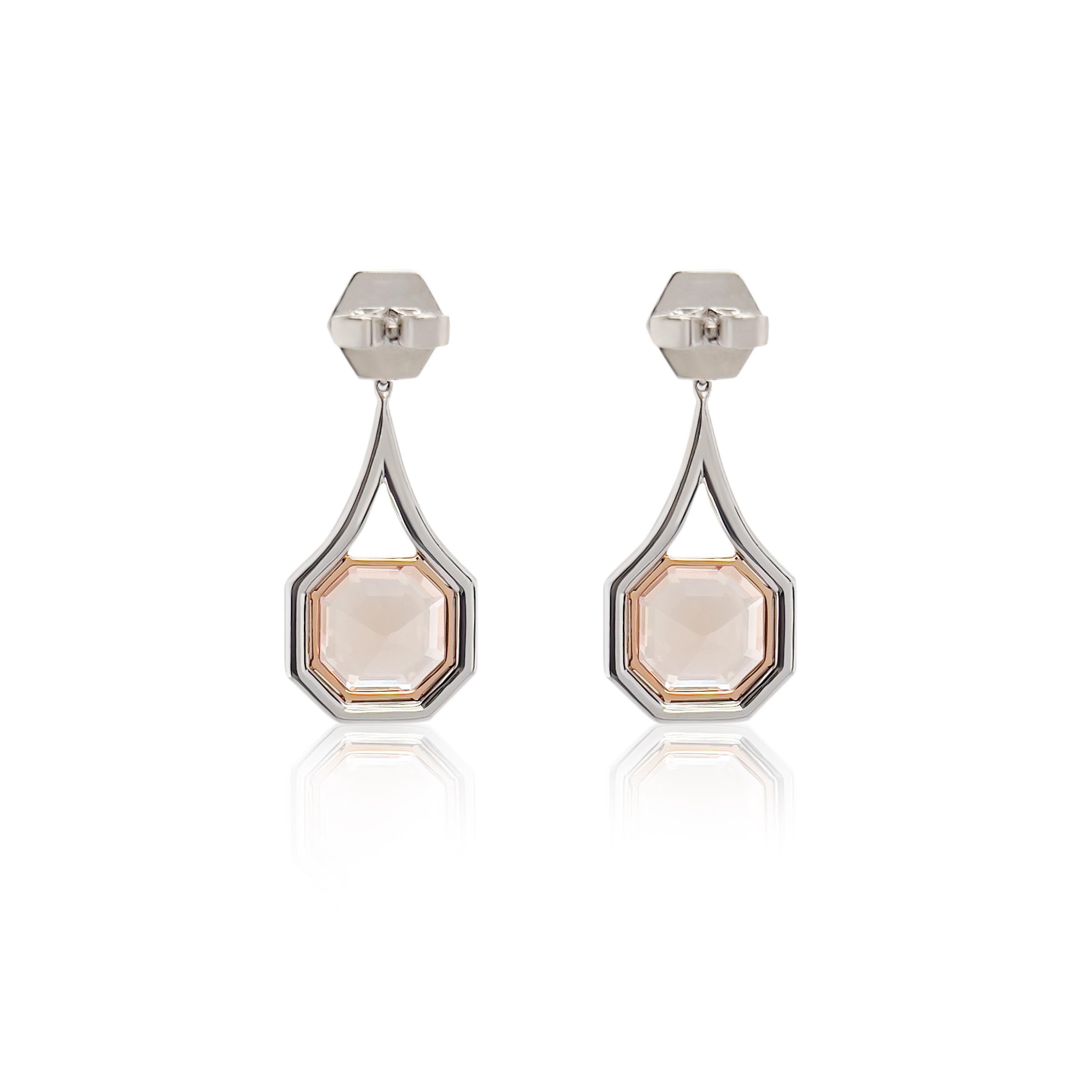 These Morganite and Diamond Dangle Earrings are a stunning edition to any jewelry collection. The earrings feature a pair of rare ascher cut morganites. The morganites are surrounded by round brilliant cut pave'd diamonds integrated into this