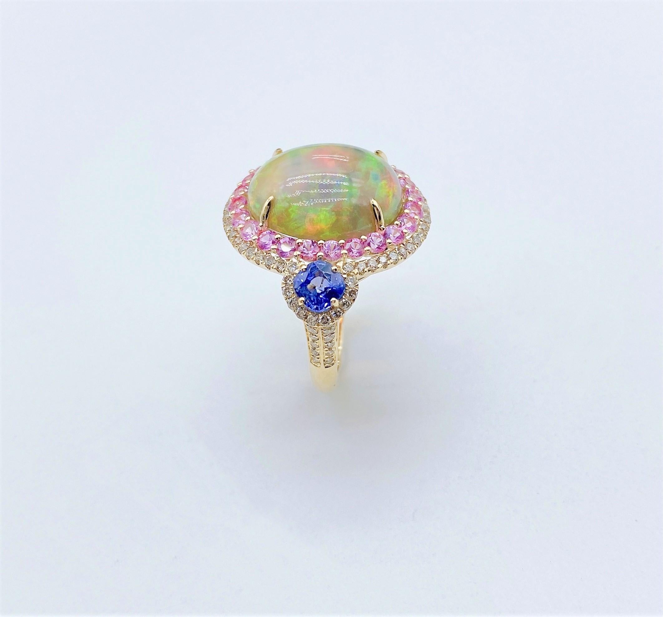 The Following Items we are offering is this Rare Important Radiant 18KT Gold LARGE Glittering and Sparkling Magnificent Fancy Multi colored Opal and Pink Sapphire Blue Sapphire White Diamond Ring. Ring Contains a Beautiful Gorgeous Large Round Opal
