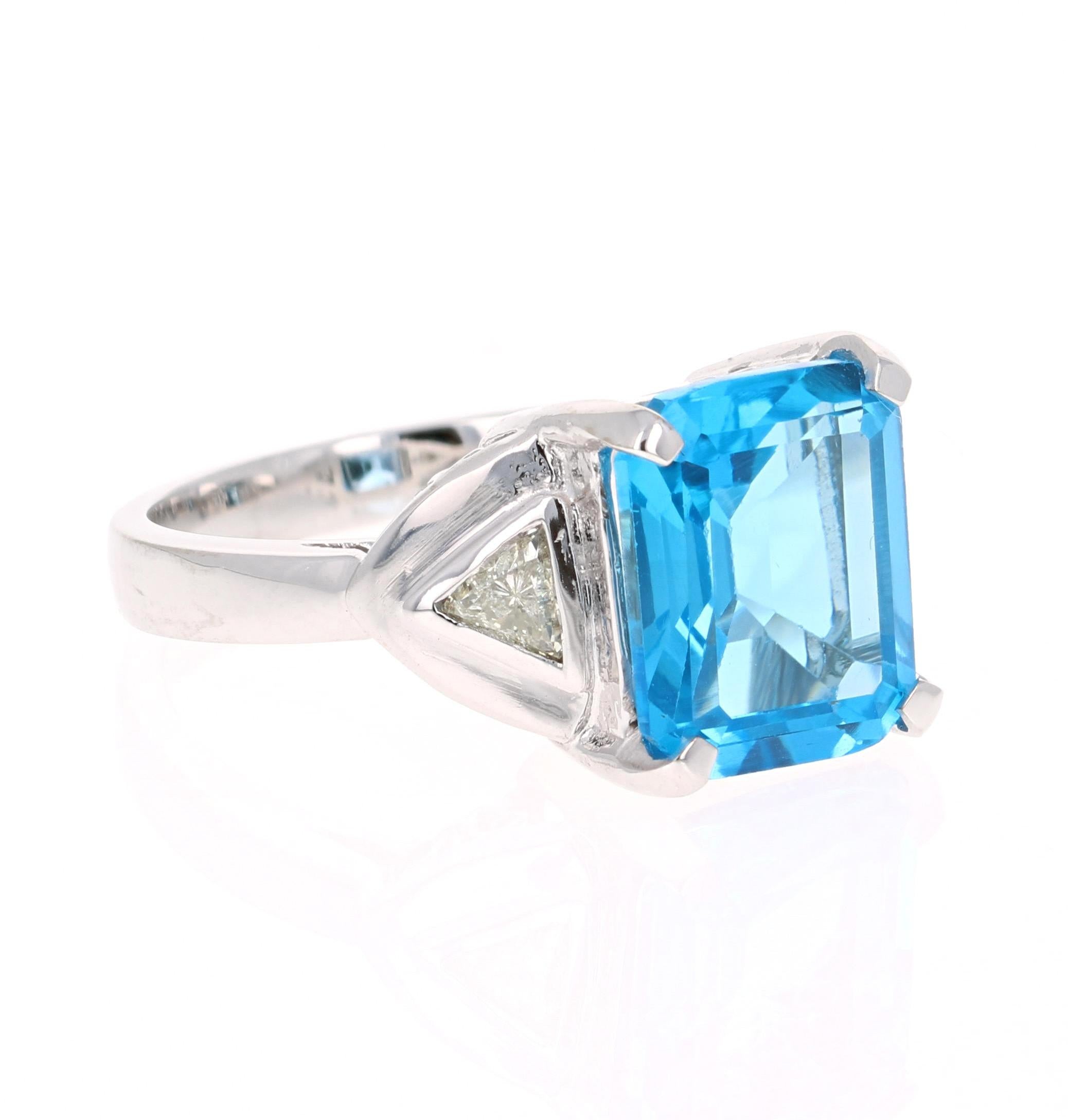 This beautiful Emerald cut Blue Topaz and Diamond ring has a stunningly large Blue Topaz that weighs 6.55 Carats. It is surrounded by 2 Trillion Cut Diamonds that weigh 0.39 Carats. The total carat weight of the ring is 6.94 Carats. 
The ring is