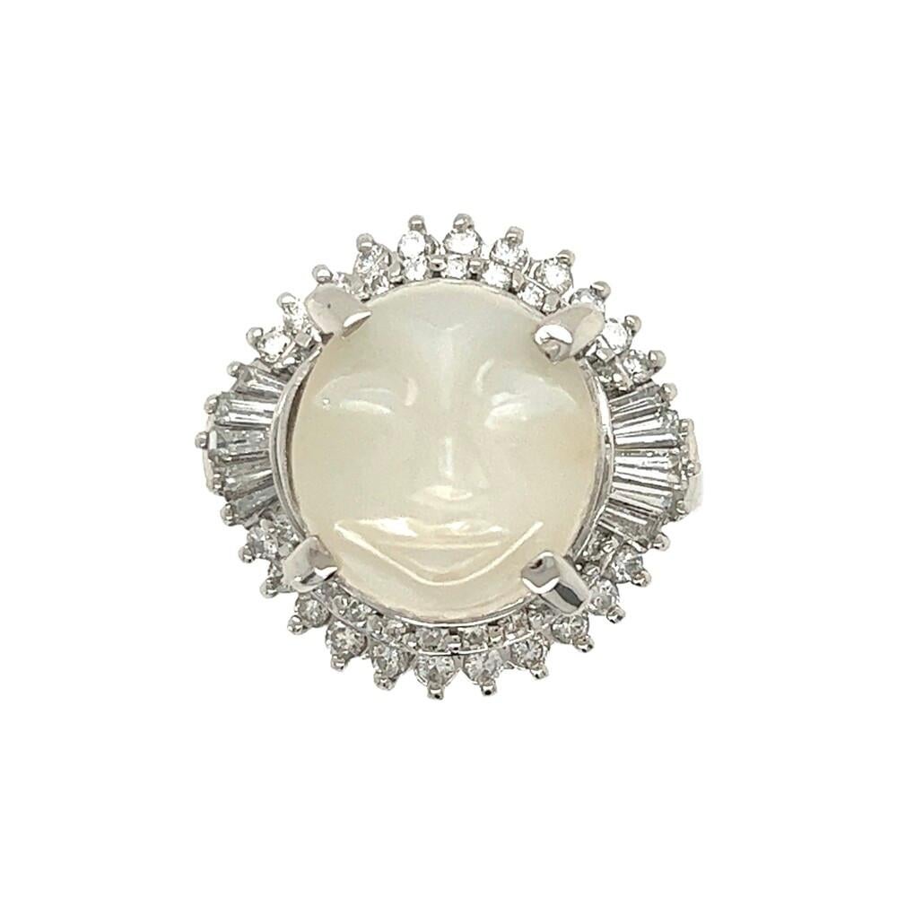 Simply Beautiful! Finely detailed Moonstone and Diamond Cocktail Ring. Centering a Hand set Carved Moonstone, weighing approx. 6.94 Carats surrounded by Tapered Baguettes, weighing approx. 0.40tcw and Round Diamonds approx. 0.61tcw. Diamonds