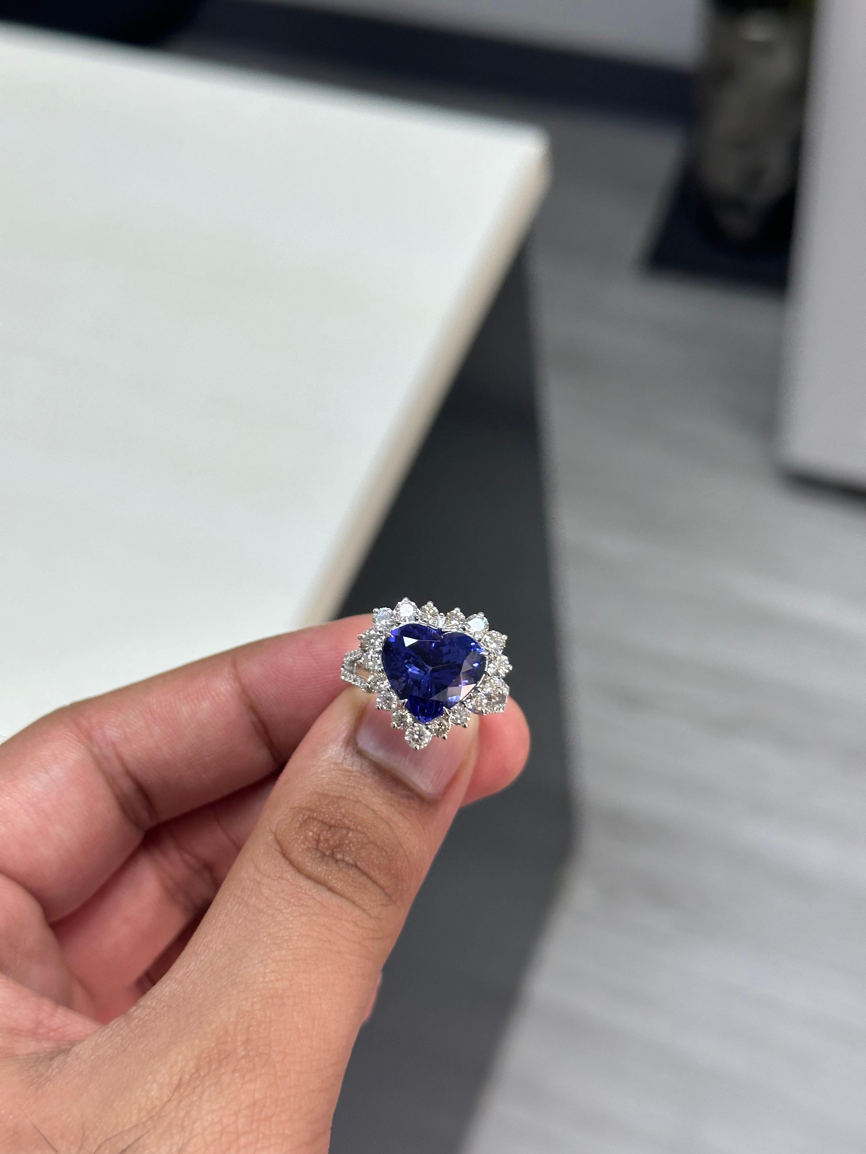 Introducing our exquisite 18K White Gold Tanzanite Ring, a true statement of luxury and elegance. This magnificent piece features a stunning 6.95 carat heart-shaped Tanzanite that has an exceptional quality and captivating royal blue color.