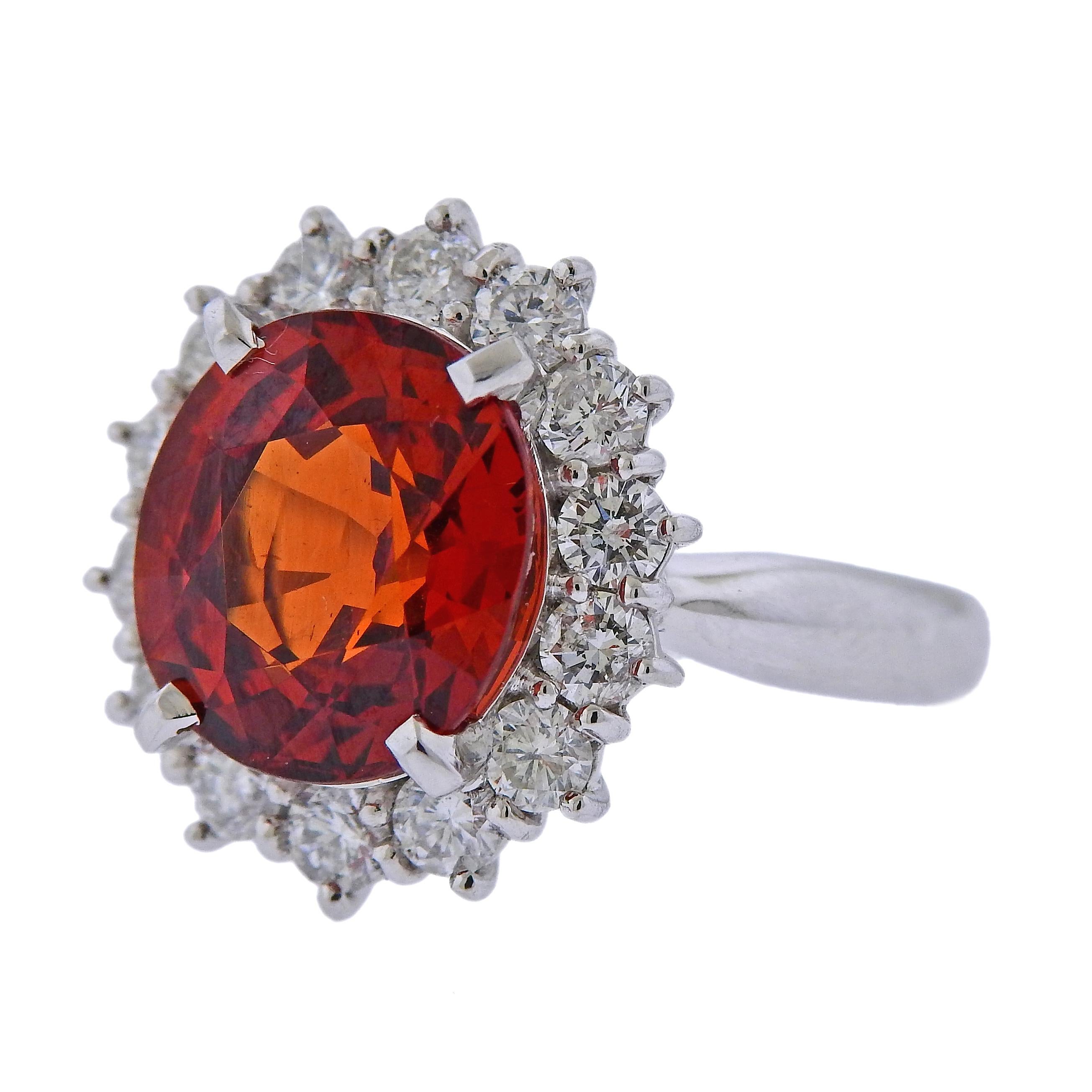 Beautiful platinum cocktail ring, set with a 6.75ct spessartite garnet, surrounded with 1.13ctw in VS/H diamonds. Ring size - 5.75, ring top is 17mm x 15mm. Weight is 11. grams. Marked Pt900, 6.95, D1.13.
