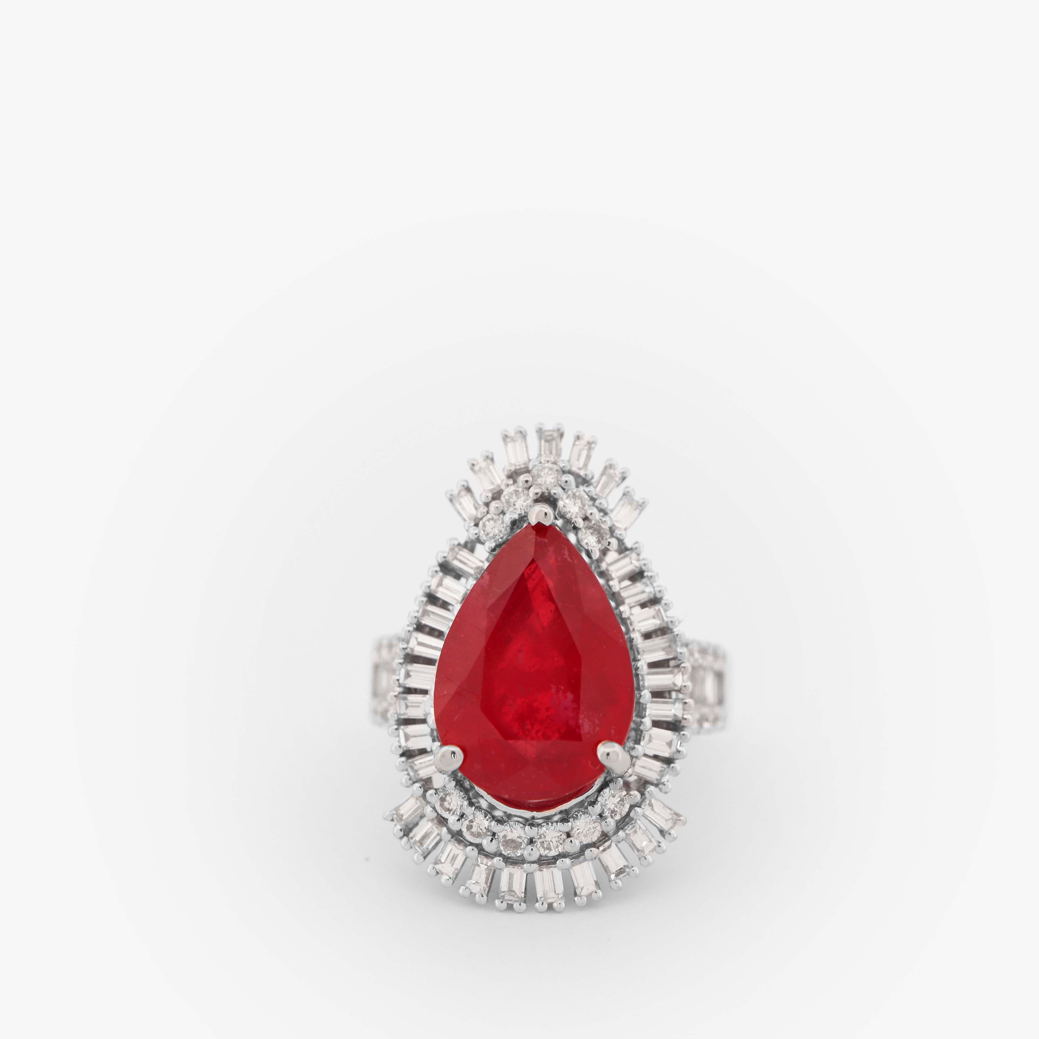 This 6.95 carat pear-shaped ruby and diamond cocktail ring, is inspired by the glamorous Art Deco era. The centerpiece of this ring is a vivid red pear-shaped ruby, weighing in at an impressive 6.95 carats, making it a true statement piece.
