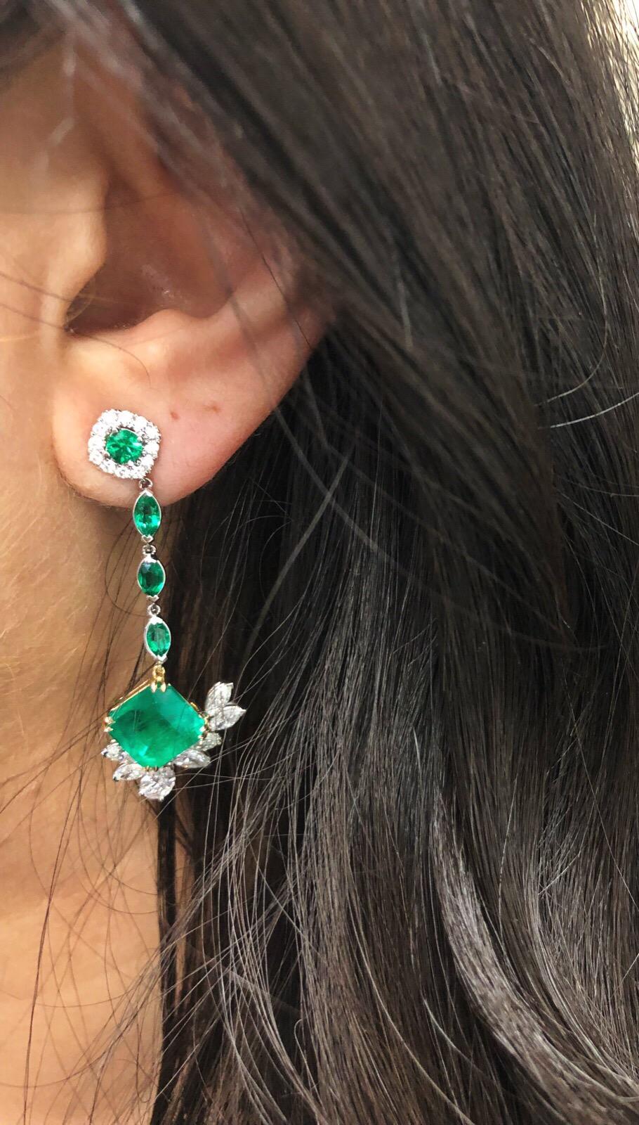 6.96 Carat total weight pair, fine vivid green Colombian emeralds, accented with .89cts in emeralds along with 2.65 total diamond weight, set in 18k white and yellow gold. Earrings convert to studs as well.  
Main stone measurements:
1) 3.14ct    