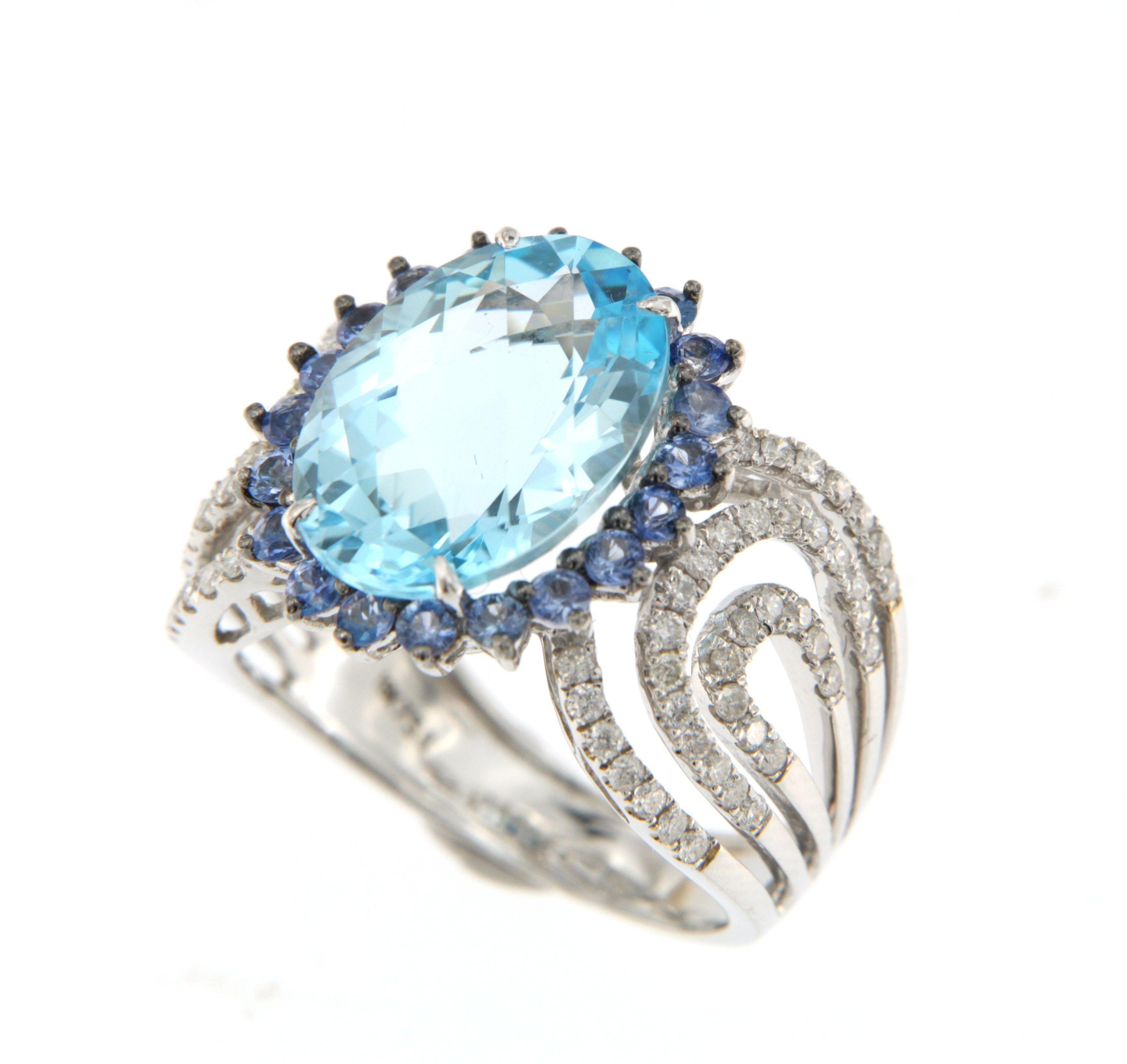 This stunning cocktail ring is a masterpiece of elegance and luxury, featuring a mesmerizing 6.96-carat oval blue topaz at its center. The vivid blue topaz is encircled by a halo of 0.71 carats of brilliant blue sapphires, enhancing its vibrant hue