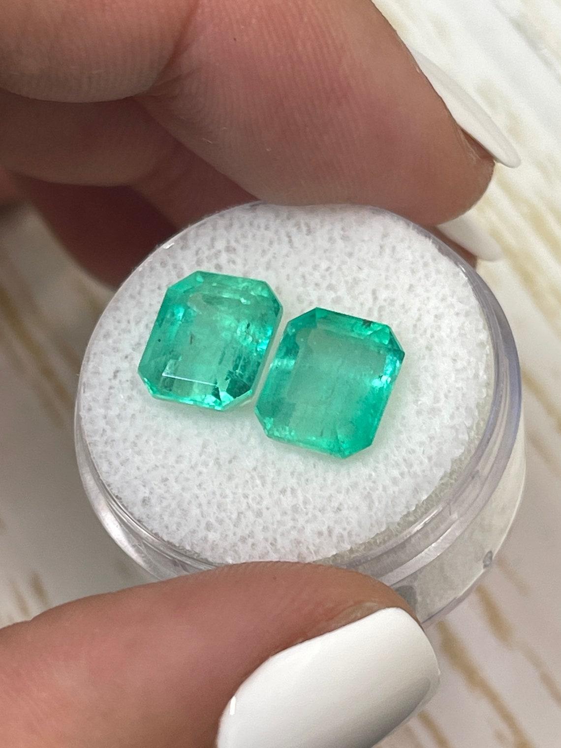 Modern 6.96tcw Matching Green Colombian Emeralds 9.5x8mm Emerald Cut Genuine Pair For Sale