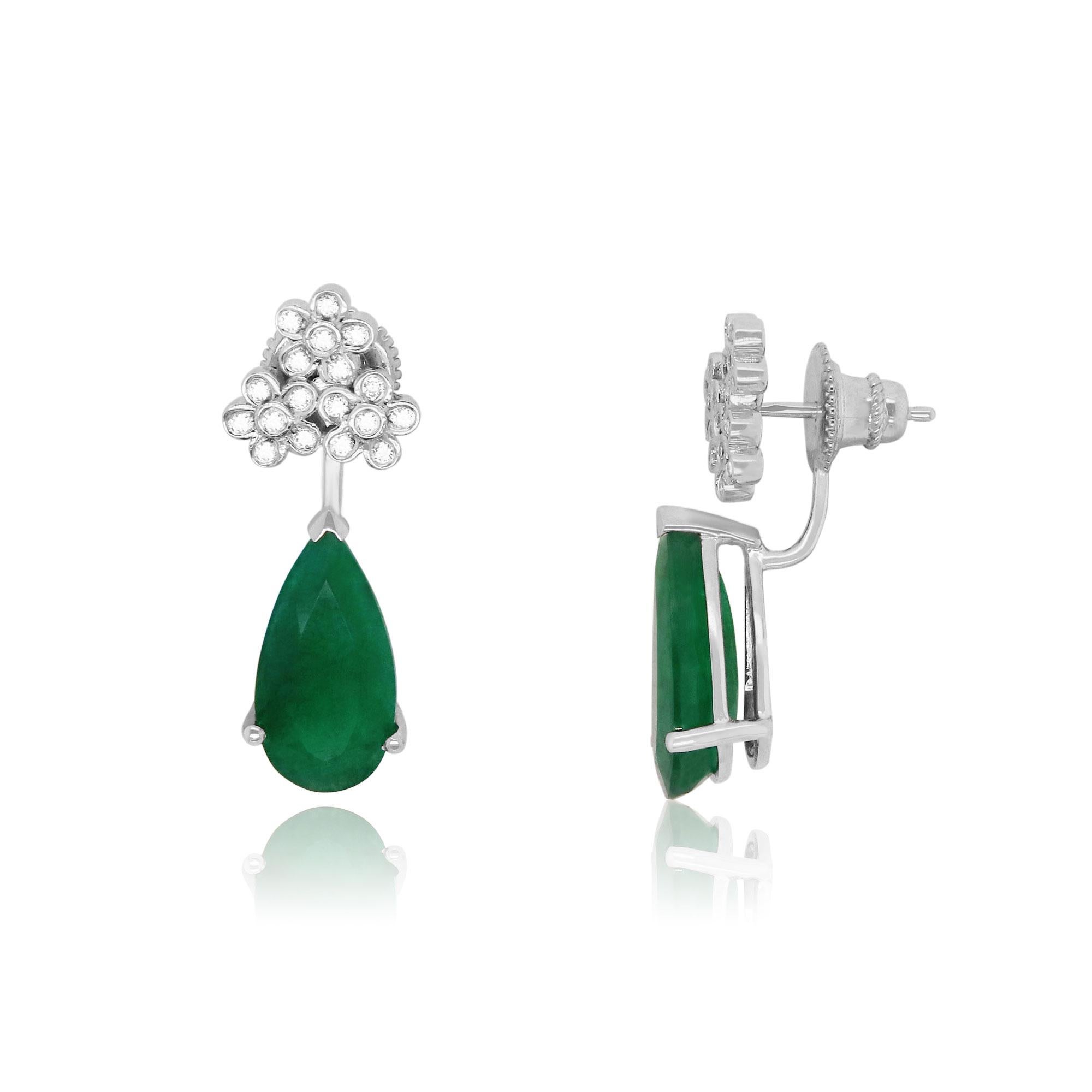 Material: 14k White Gold 
Stone Details: 2 Pear Shaped Emeralds at 6.97 Carats Total
Diamond Details: 36 Brilliant Round White Diamonds at 0.34 Carats. Clarity: SI / Color: H-I

Fine one-of-a-kind craftsmanship meets incredible quality in this