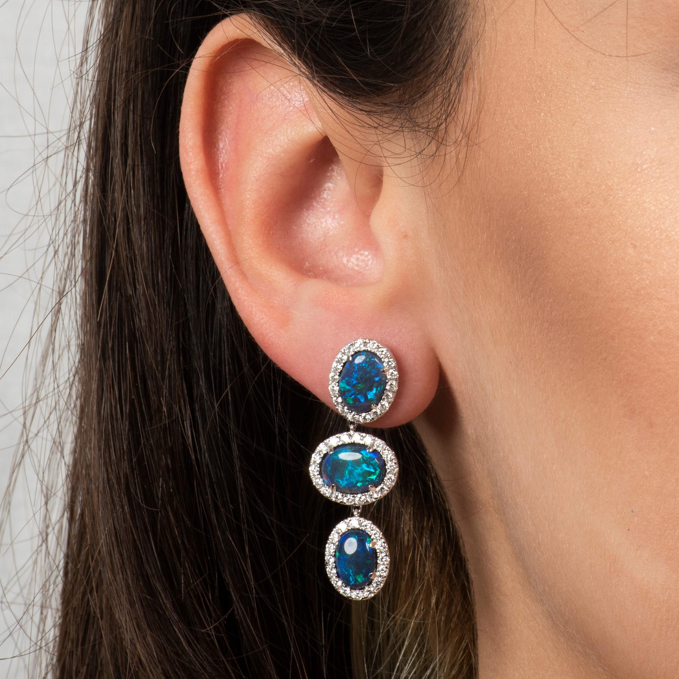 These drop earrings feature six Lightning Ridge Australian opals at a total weight of 6.87ct, including halos of pave round cut diamonds at a total weight of 1.57ct. They are set in 18kt white gold.