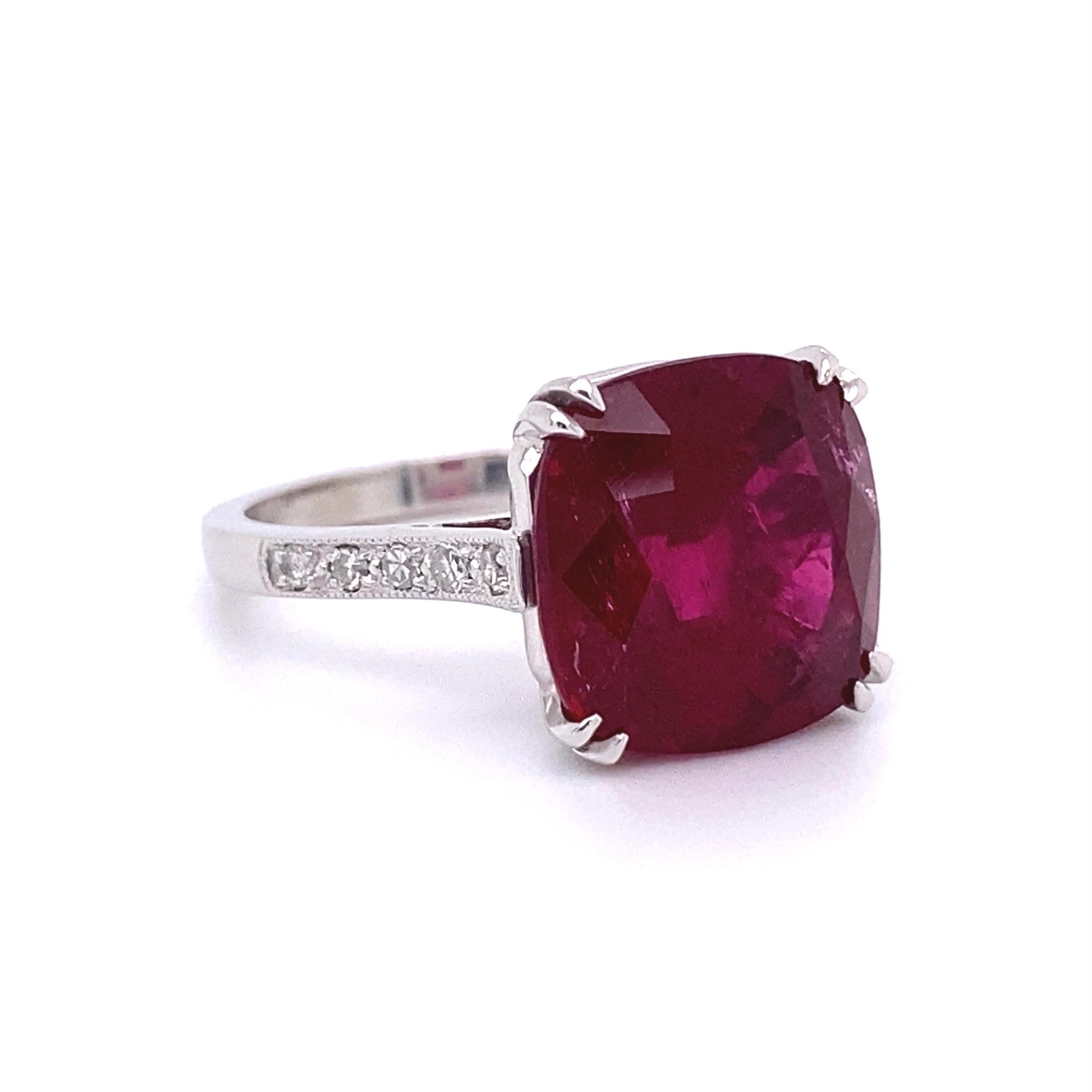 Beautiful and finely detailed Cocktail Ring center Hand set with a securely nestled 6.98 Carat Cushion-cut Rubelite Tourmaline and enhanced with Diamonds on either side. Dimensions 0.79”w x 0.47”h x 1.06” d. Hand crafted in Platinum. In excellent