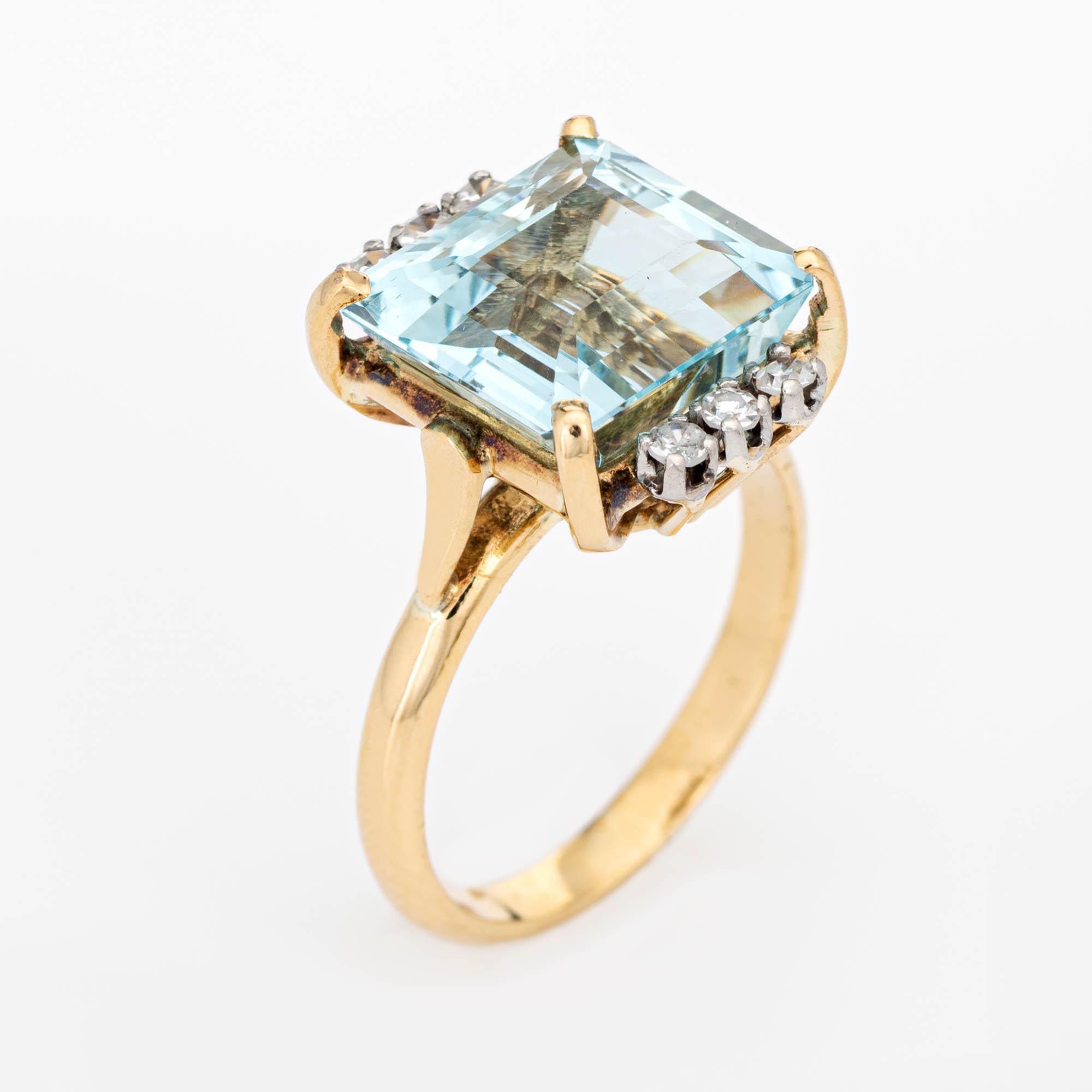 Stylish vintage aquamarine & diamond cocktail ring (circa 1960s to 1970s) crafted in 18 karat yellow gold and platinum. 

Emerald cut aquamarine measures 11.5mm x 10.33 (estimated at 6 carats), accented with six estimated 0.03 carat single cut