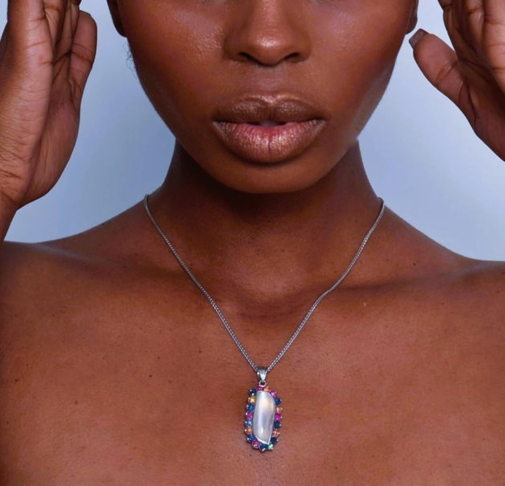 Our exquisite Pendant Necklace featuring a 6ct Oval Free-Form Natural Origin Moonstone—the focal point of a mesmerizing dance of colors. This wearable masterpiece is surrounded by a symphony of gemstones.

Key Features:
Oval Free-Form Moonstone: 6ct