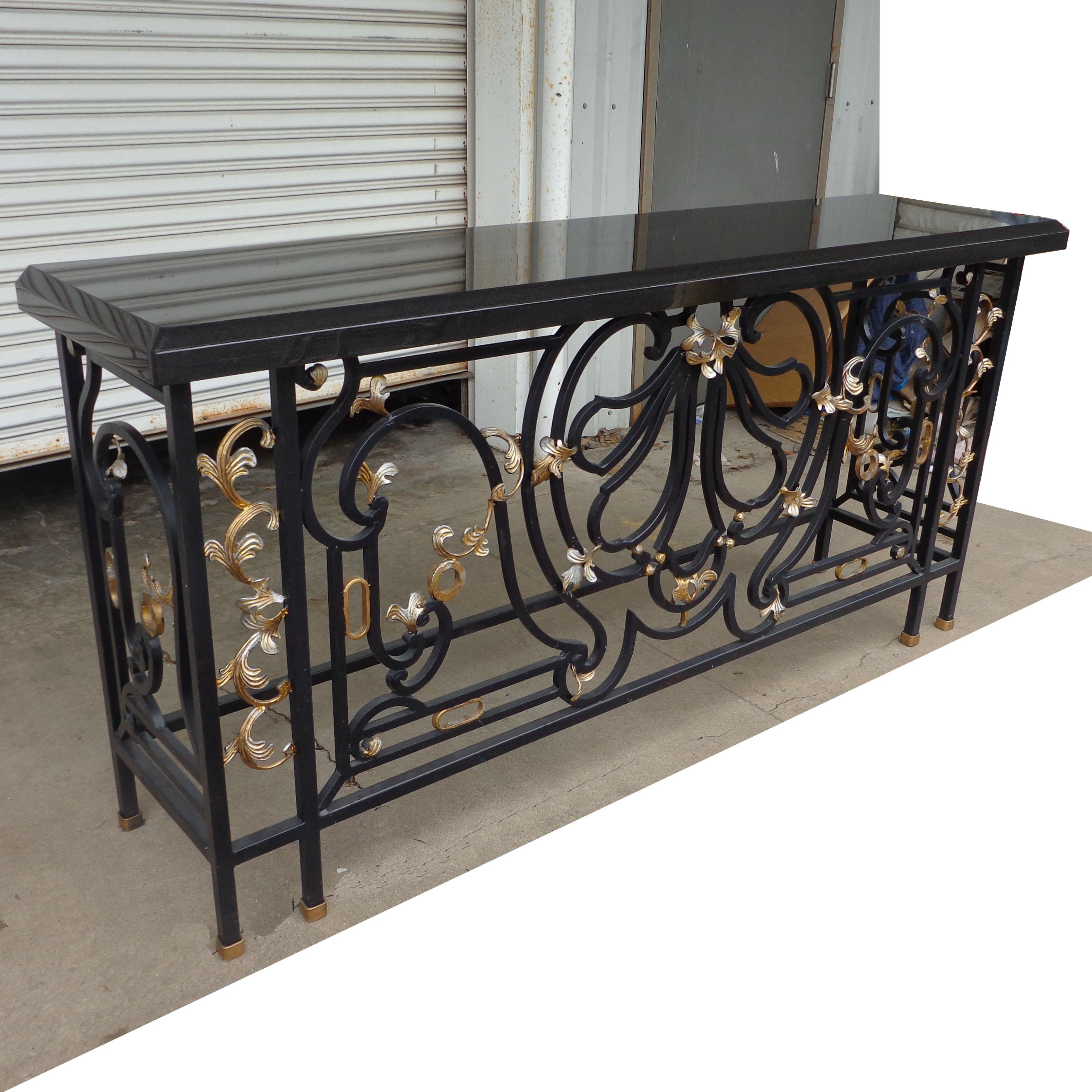 Vintage granite wrought iron console. Measure: 6ft.

Scrolled wrought iron base adorned with gilt leaf accents. Top is a rich black granite. 



 