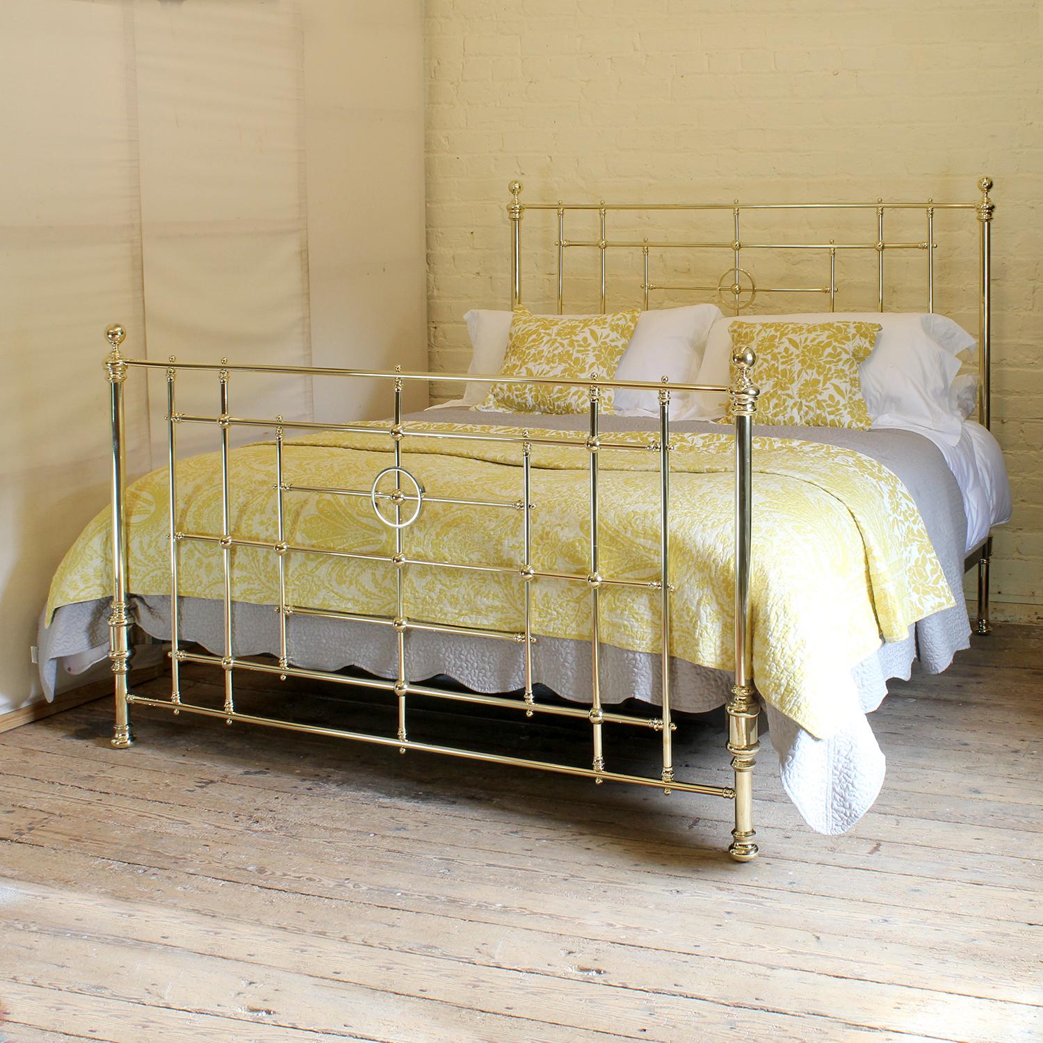 6ft wide Victorian antique brass bed with central ring decoration on the head and foot panels. This elegant design of a brass bed was quite rare being 6ft wide.

This bed accepts a Californian king size. or British super king size (72 inches, 6ft or