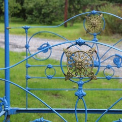6ft wide cast iron antique four poster bed with ornate castings and fine canopy