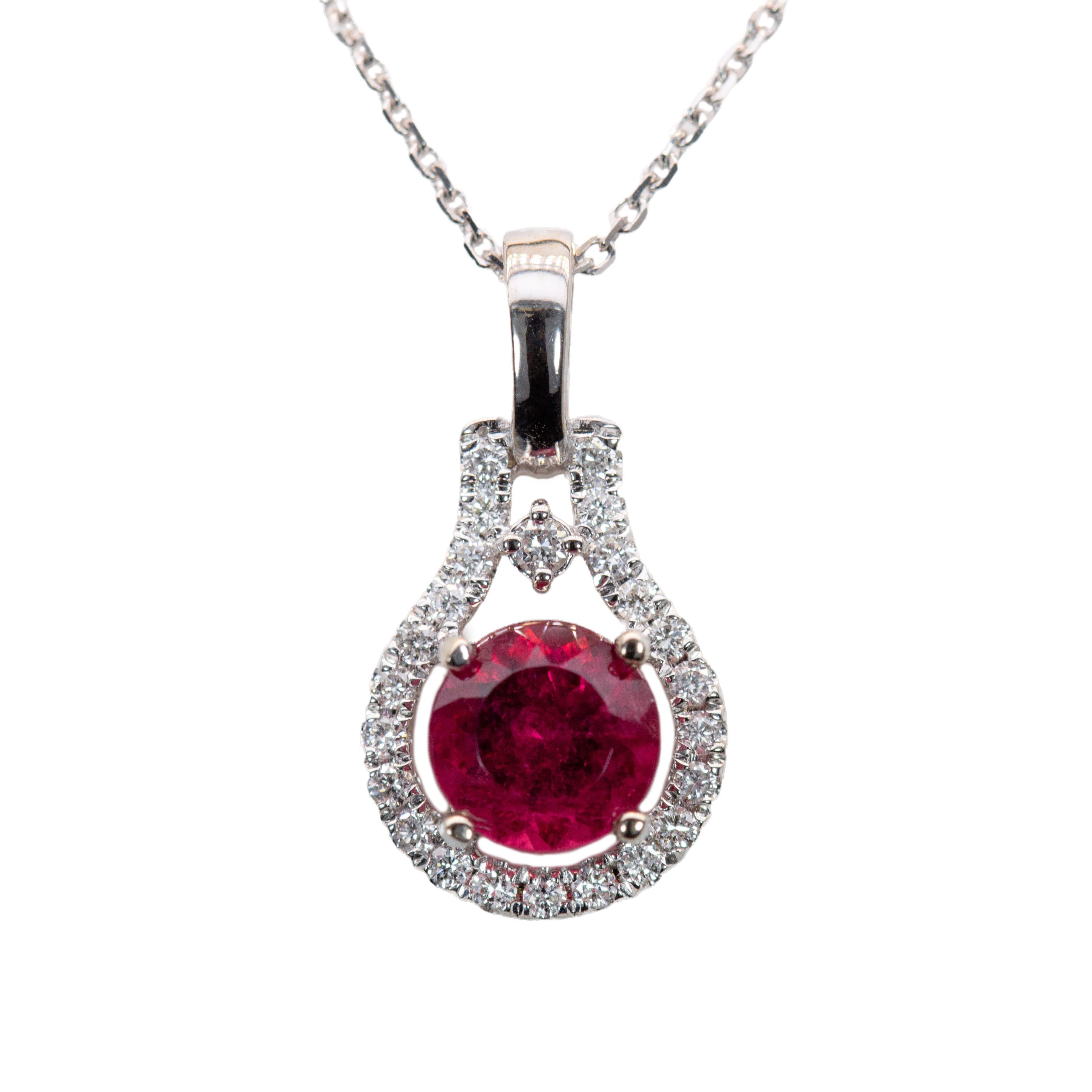 A celebration of color and craftsmanship, this round pendant features a 0.98 carat rubellite tourmaline encircled by a luminous diamond halo, all set in solid 14k white gold. The perfect balance of feminine energy and refined sparkle—made to dazzle,