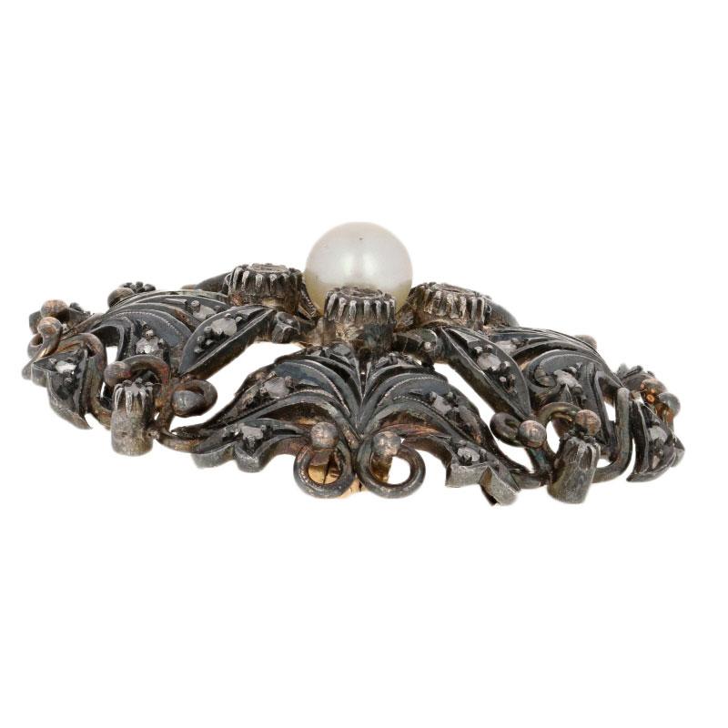 This beautiful Victorian piece will be a charming addition to your jewelry collection! Created in 18k yellow gold and silver, this antique brooch features a botanical-inspired design adorned with a luminous cultured pearl and rose cut diamonds. The