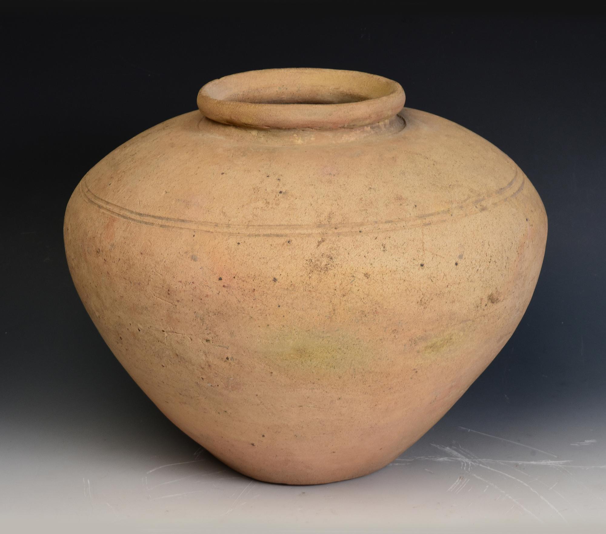 Antique Khmer pottery jar.

Age: Cambodia, Pre-Angkor Period, 6th - 7th Century
Size: Height 28.4 C.M. / Width 35 C.M.
Condition: Nice and condition overall (some expected degradation due to its age).

100% satisfaction and authenticity guaranteed
