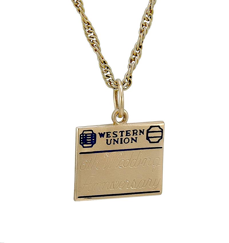 Unique anniversary charm, in the form of a Western Union telegram.  14K gold with blue enameling.  The telegram is engraved 