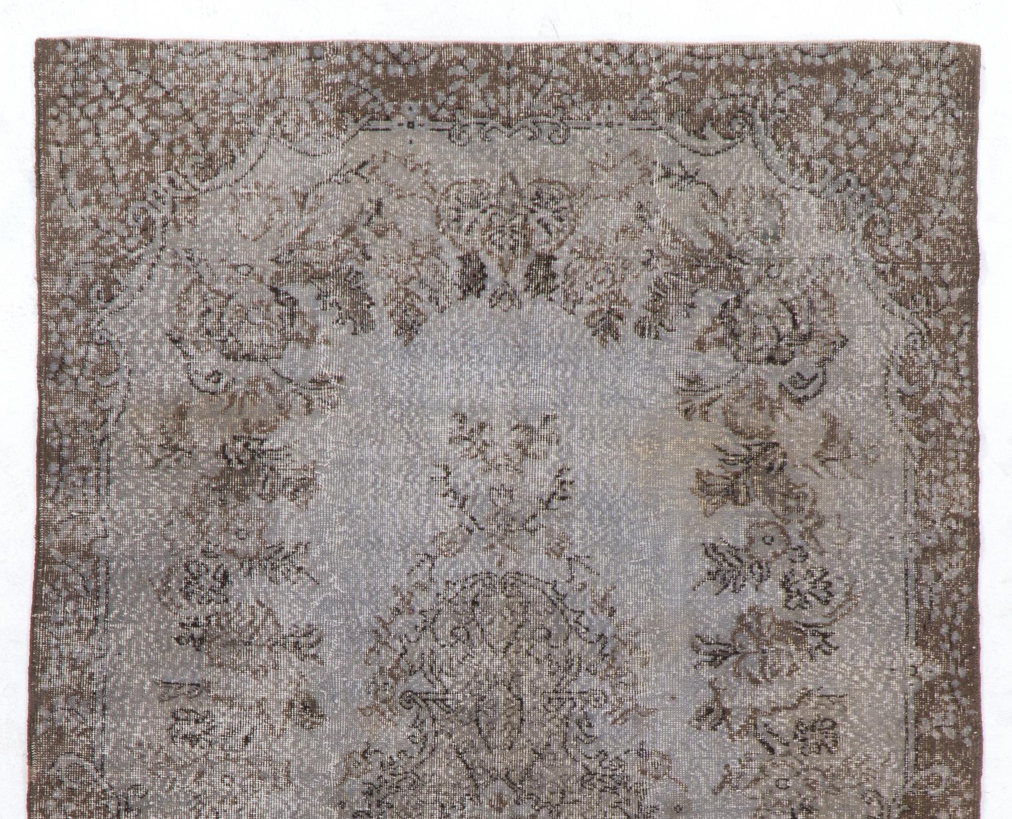 A vintage Turkish area rug re-dyed in gray color. Ideal for both residential and commercial interiors. Measures: 6 x 10 ft.
Finely hand knotted, low wool pile on cotton foundation. Professionally washed.
Sturdy and can be used on a high traffic