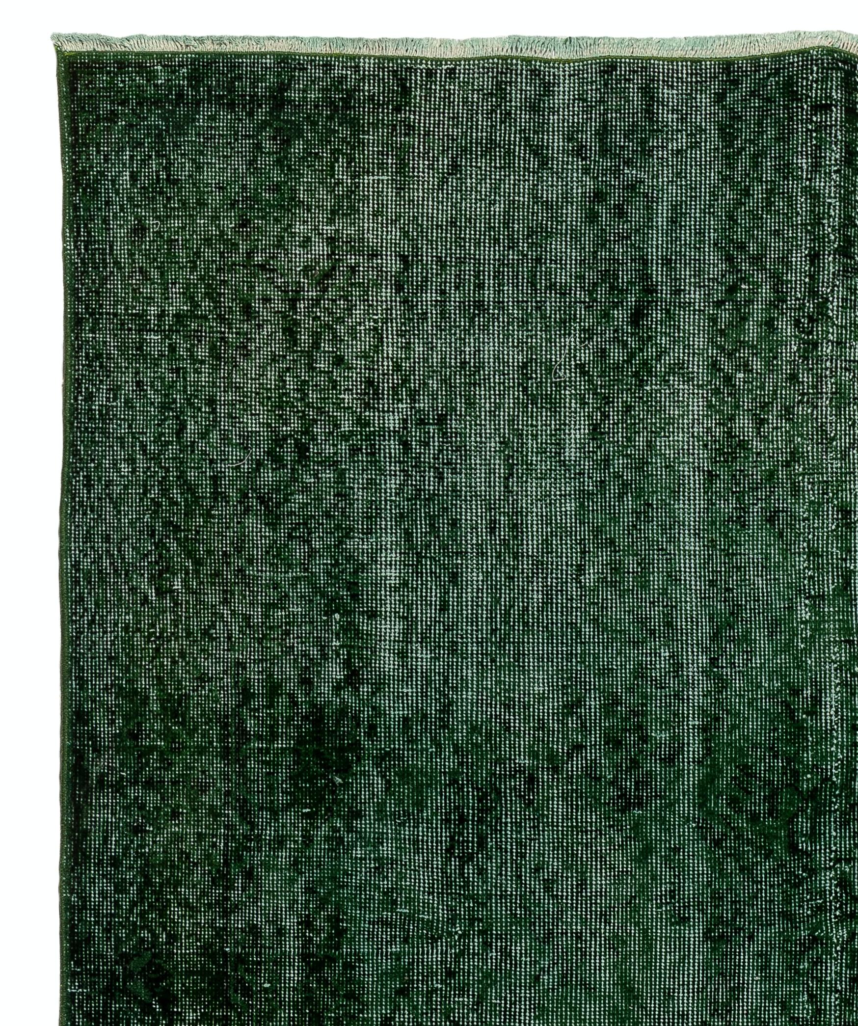 A vintage Turkish area rug re-dyed in green color for contemporary interiors. Measures: 6 x 10.2 ft.
Finely hand knotted, low wool pile on cotton foundation. Professionally washed.
Sturdy and can be used on a high traffic area, suitable for both