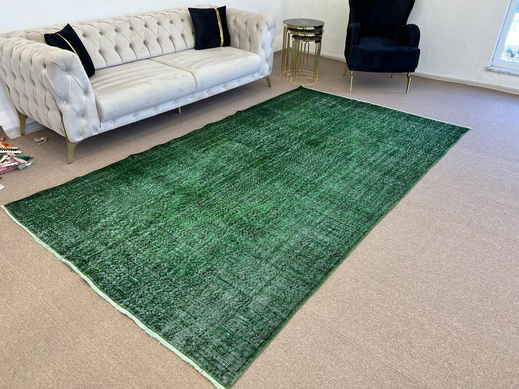 A vintage Turkish area rug re-dyed in green color for contemporary interiors. 
Finely hand knotted, low wool pile on cotton foundation. Professionally washed.
Sturdy and can be used on a high traffic area, suitable for both residential and