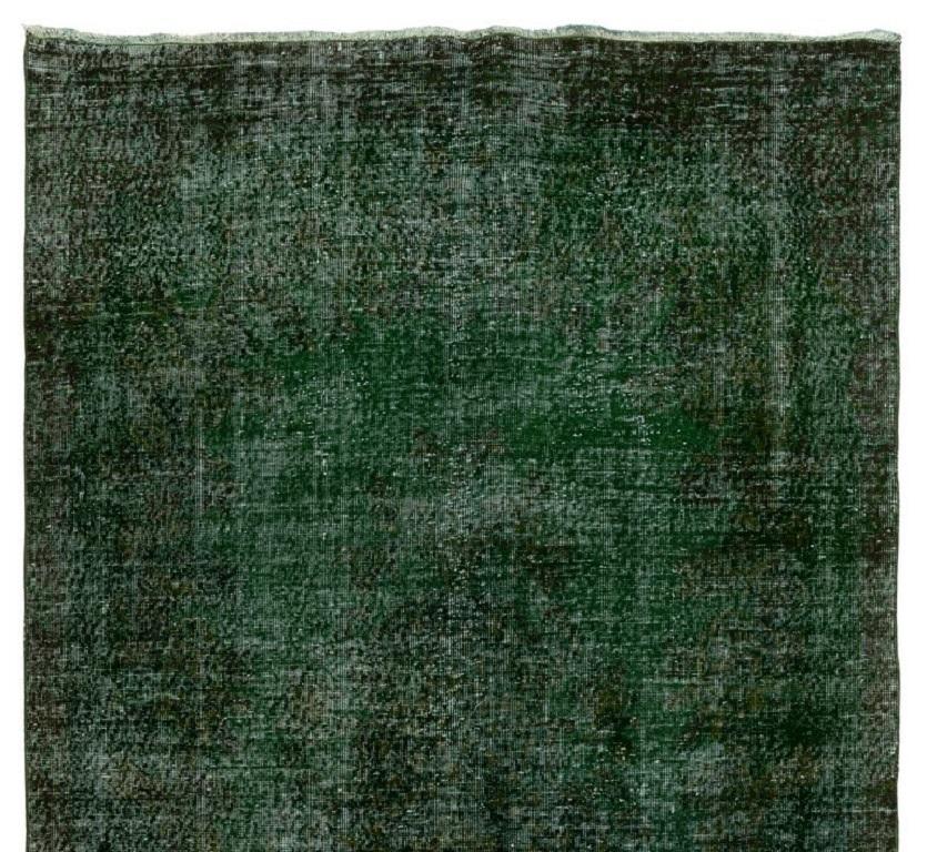 A vintage Turkish area rug re-dyed in green color for contemporary interiors. Measures: 6 x 11 ft.
Finely hand knotted, low wool pile on cotton foundation. Professionally washed.
Sturdy and can be used on a high traffic area, suitable for both