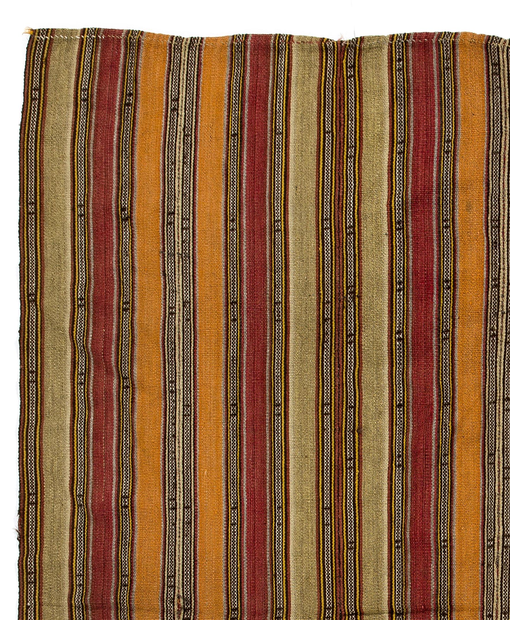This authentic handwoven flat-weave (Kilim) from Central Turkey was made by Nomads to be used as a floor covering in their tents or summer houses circa mid-20th century. These vintage utilitarian Kilims were made to use for everyday life rather than