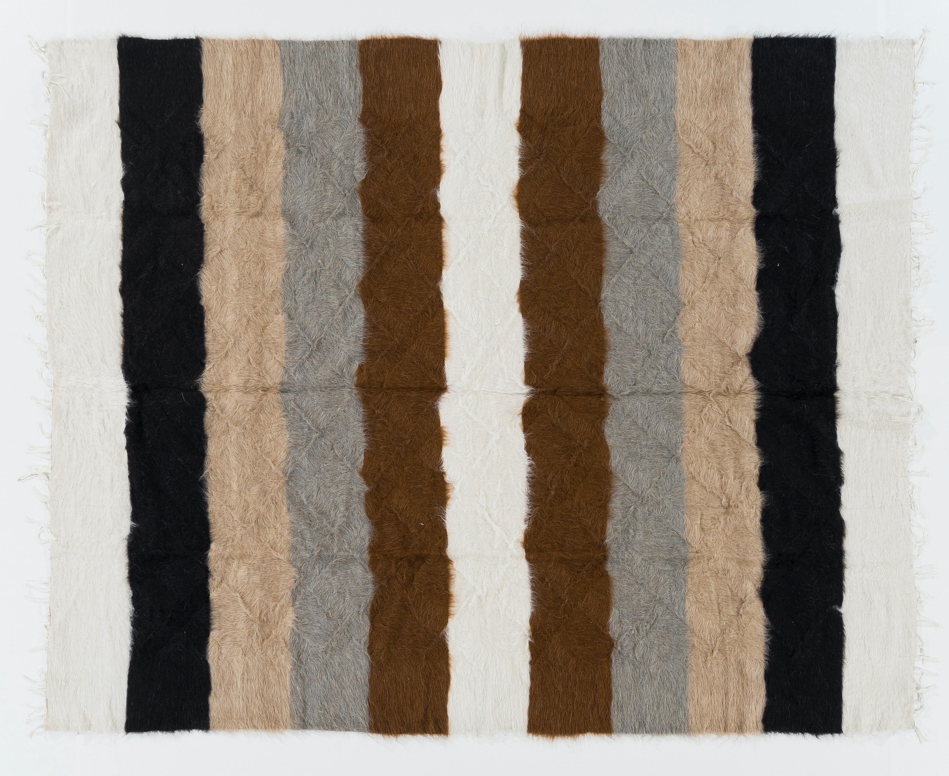 A handwoven flat-weave rug from Eastern Turkey. It is made of soft Undyed Natural Mohair wool and loosely woven compared to traditional Kilims therefore it is very soft and floppy. Measures 6 x 7.4 Ft
It can be used as a blanket, a bed cover, sofa