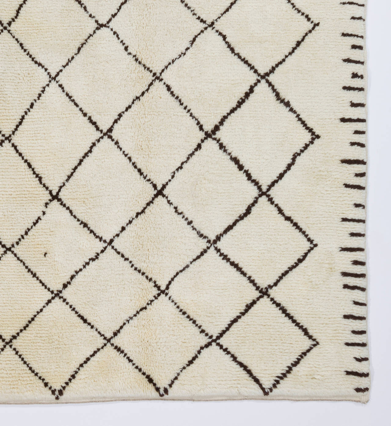A contemporary handmade rug made of natural un-dyed cream/ivory and dark brown sheep wool. The design is based on vintage Moroccan rugs. 

The rug is available as seen or if requested, it can be custom produced in a different size, color combination