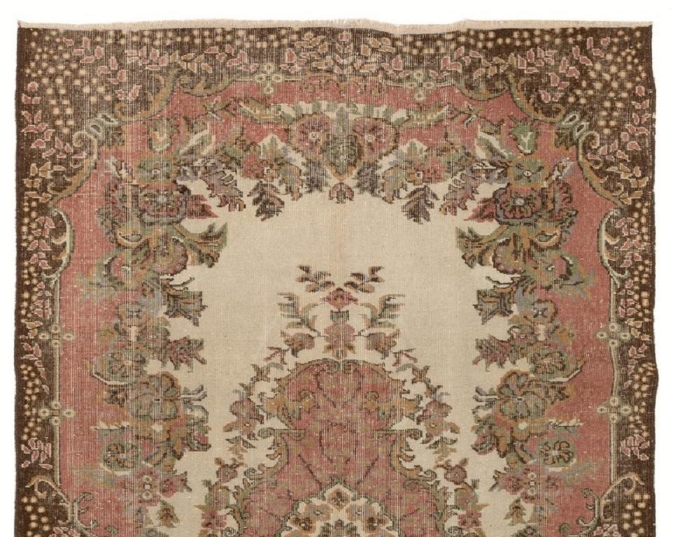 A finely hand-knotted vintage Turkish carpet from 1960s featuring a baroque design. The rug has even low wool pile on cotton foundation. It is heavy and lays flat on the floor, in very good condition with no issues. It has been washed