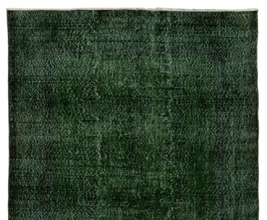 A vintage distressed Turkish area rug over-dyed in dark emerald green for contemporary interiors.
Finely hand-knotted. Low wool pile on cotton foundation. Professionally washed.
Sturdy and can be used on a high traffic area, suitable for both