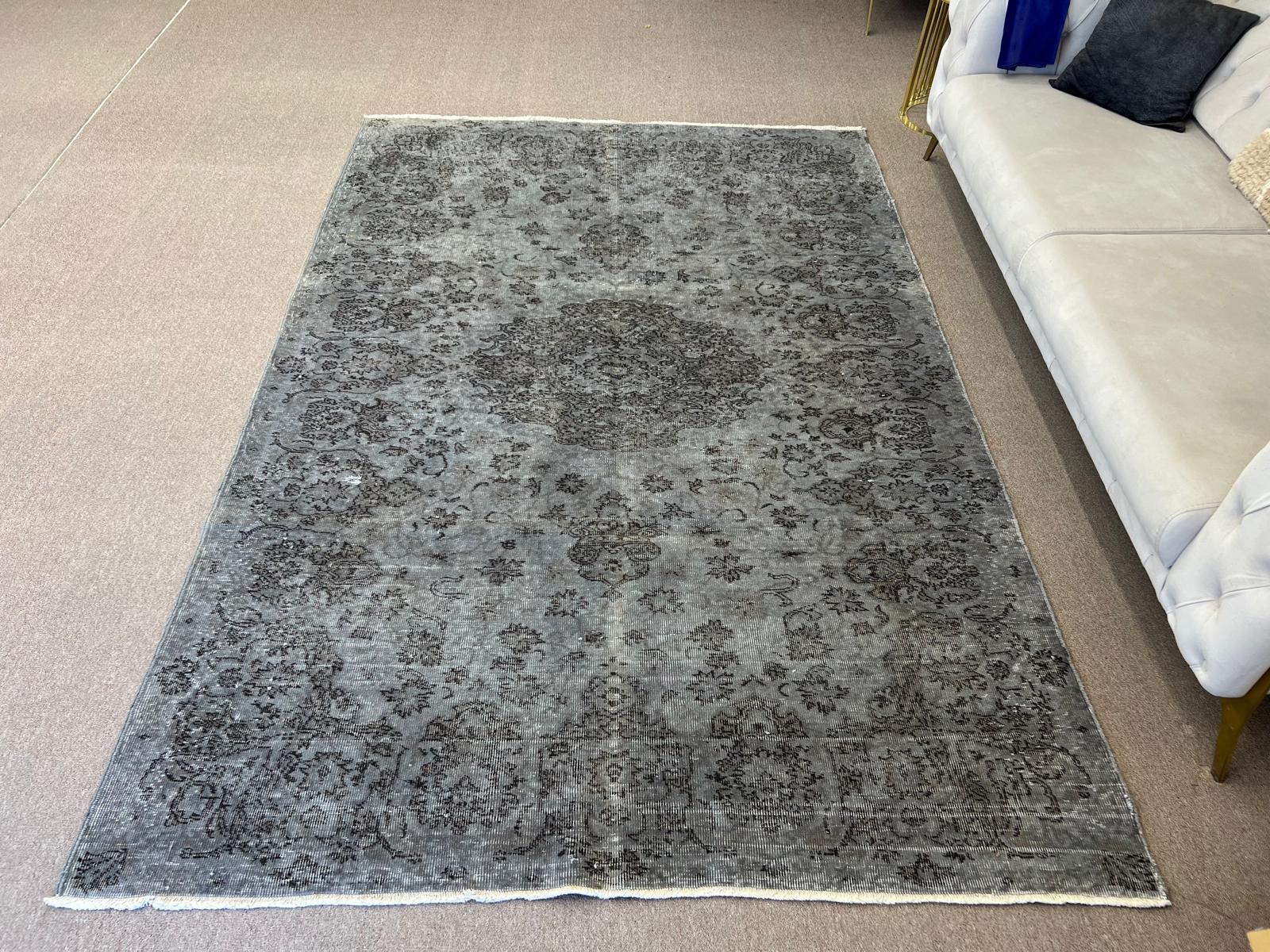 A vintage Turkish area rug hand-knotted in the 1960s with low wool pile on cotton foundation with a medallion design. The rug was over-dyed in charcoal gray. It is in good condition, professionally washed, sturdy and suitable for areas with high