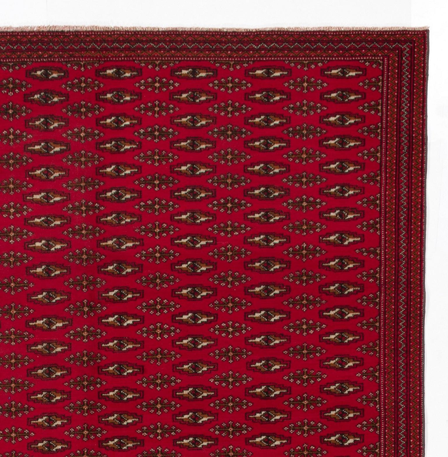 A vintage handmade rug from Turkmenistan with a traditional all-over small pattern 
