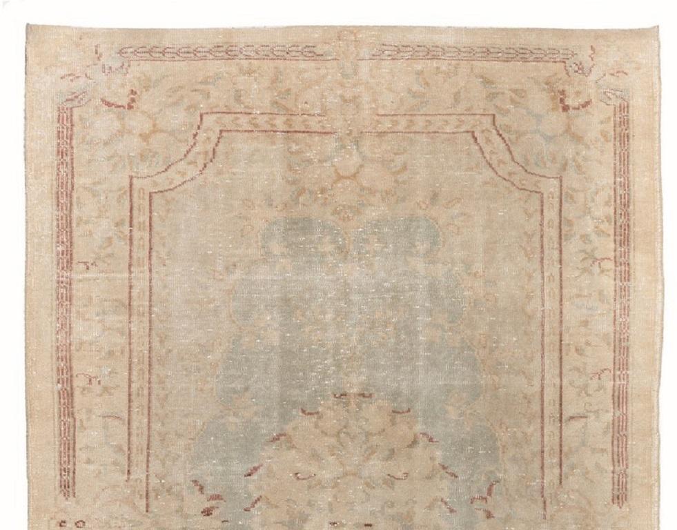 A one-of-a-kind vintage hand-knotted French-Aubusson inspired Turkish area rug from the 1960s with low wool pile on cotton foundation, in powder blue, sand beige and madder red. The rug is in very good condition with no issues, professionally
