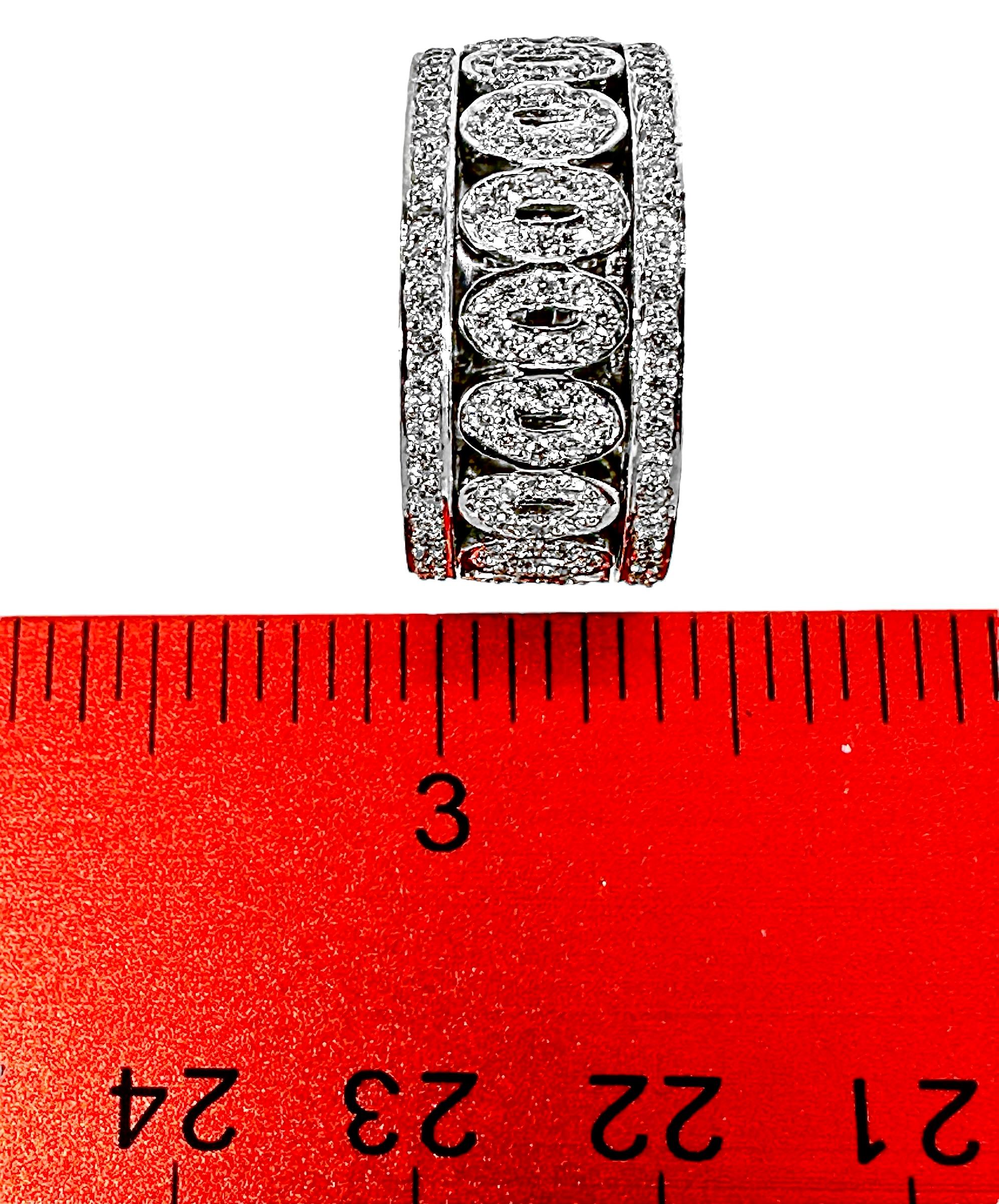 An 18K white gold band featuring two rows of diamonds, with pave' set oval motifs in between. The use of pave' setting and the finely made gallery result in a ring that has a lower profile and is more comfortable to wear. The round brilliant cut