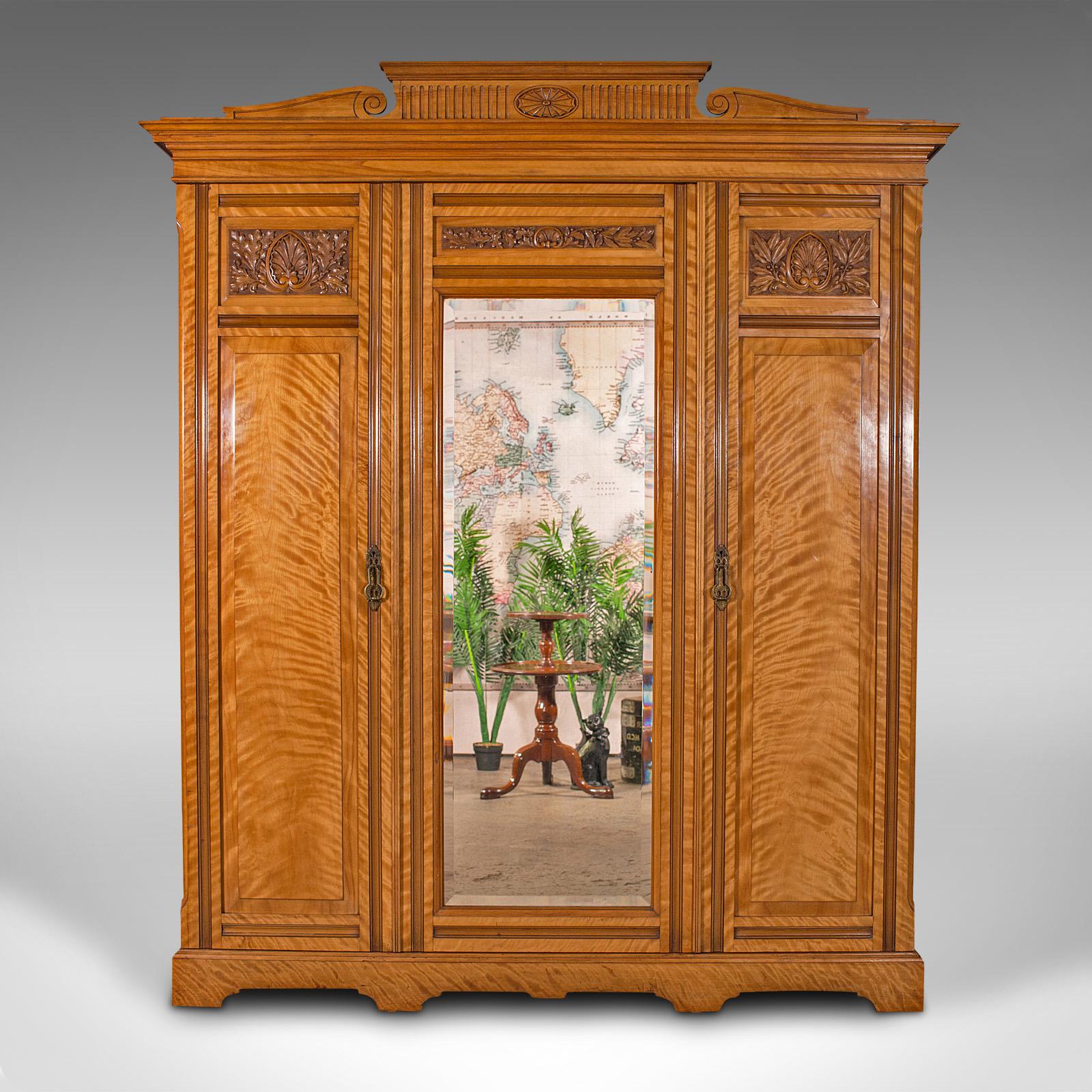This is an exceptional antique triple wardrobe. A Scottish, satinwood dressing cupboard with mirror by Taylor & Sons of Edinburgh, dating to the late Victorian period, circa 1890.

Striking craftsmanship and figuring for the grandest of